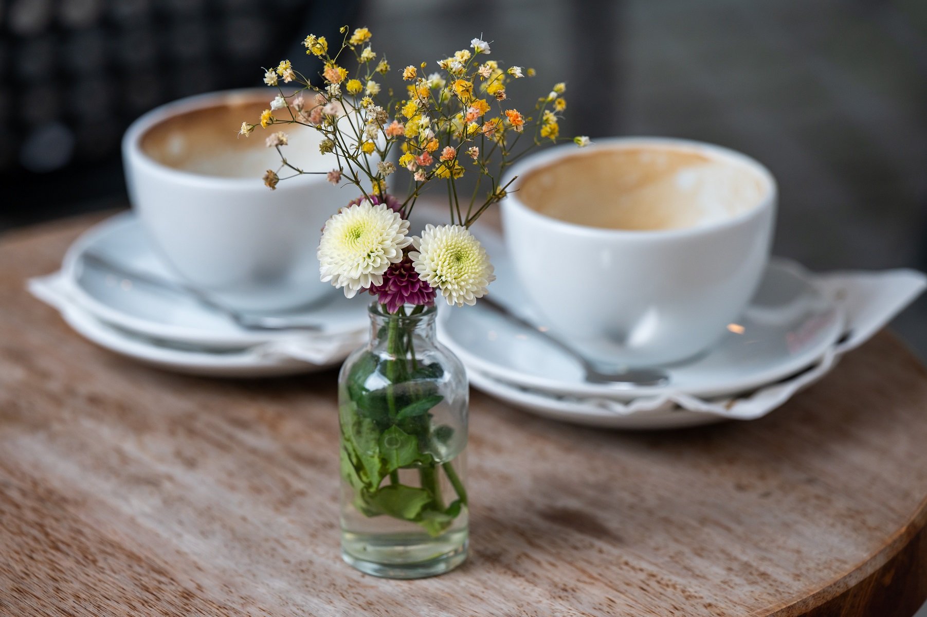 Two coffee cups are seen on a table. Coffee drinks are celebrating National Coffee Day on September 29