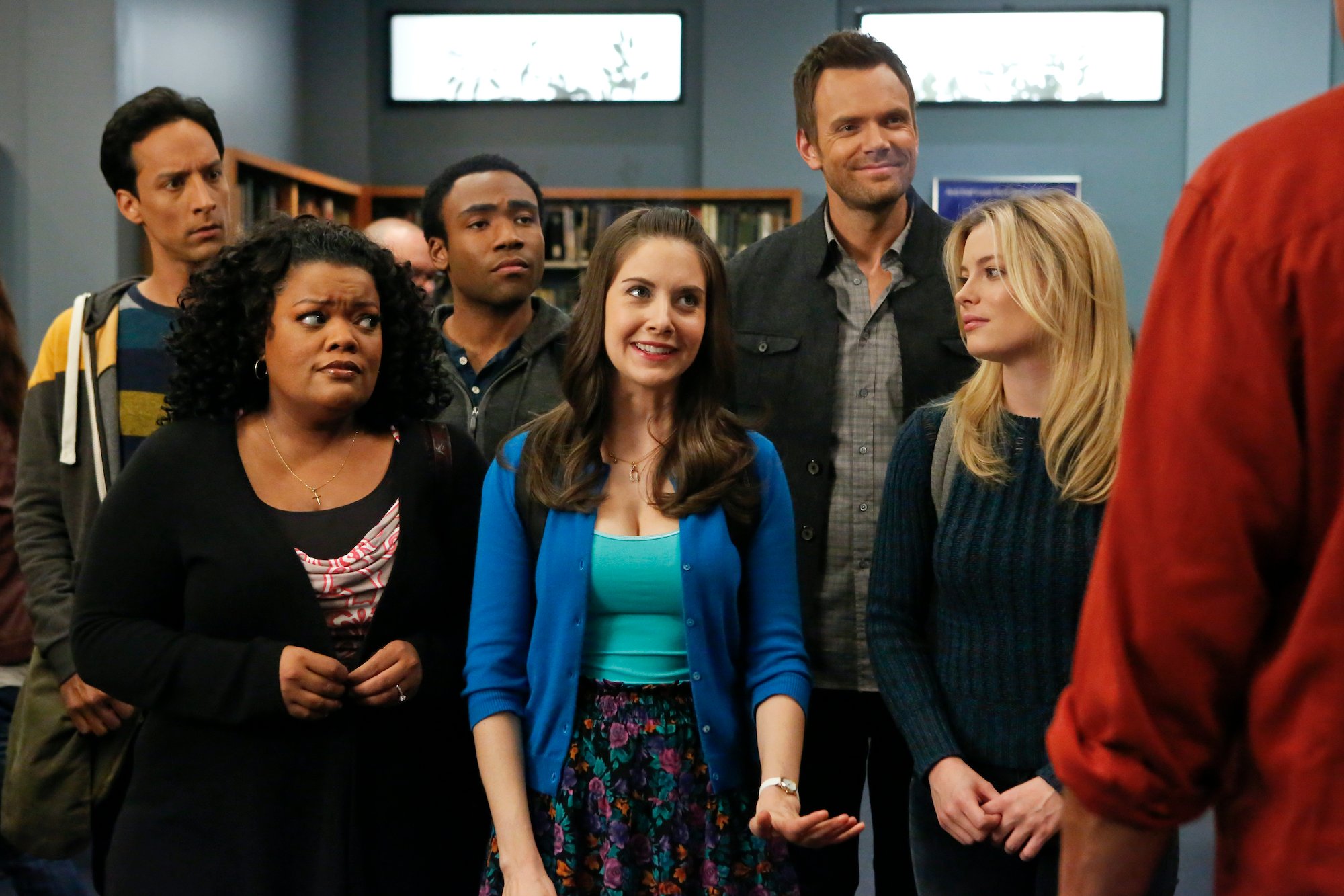 Cast of 'Community' standing in a library