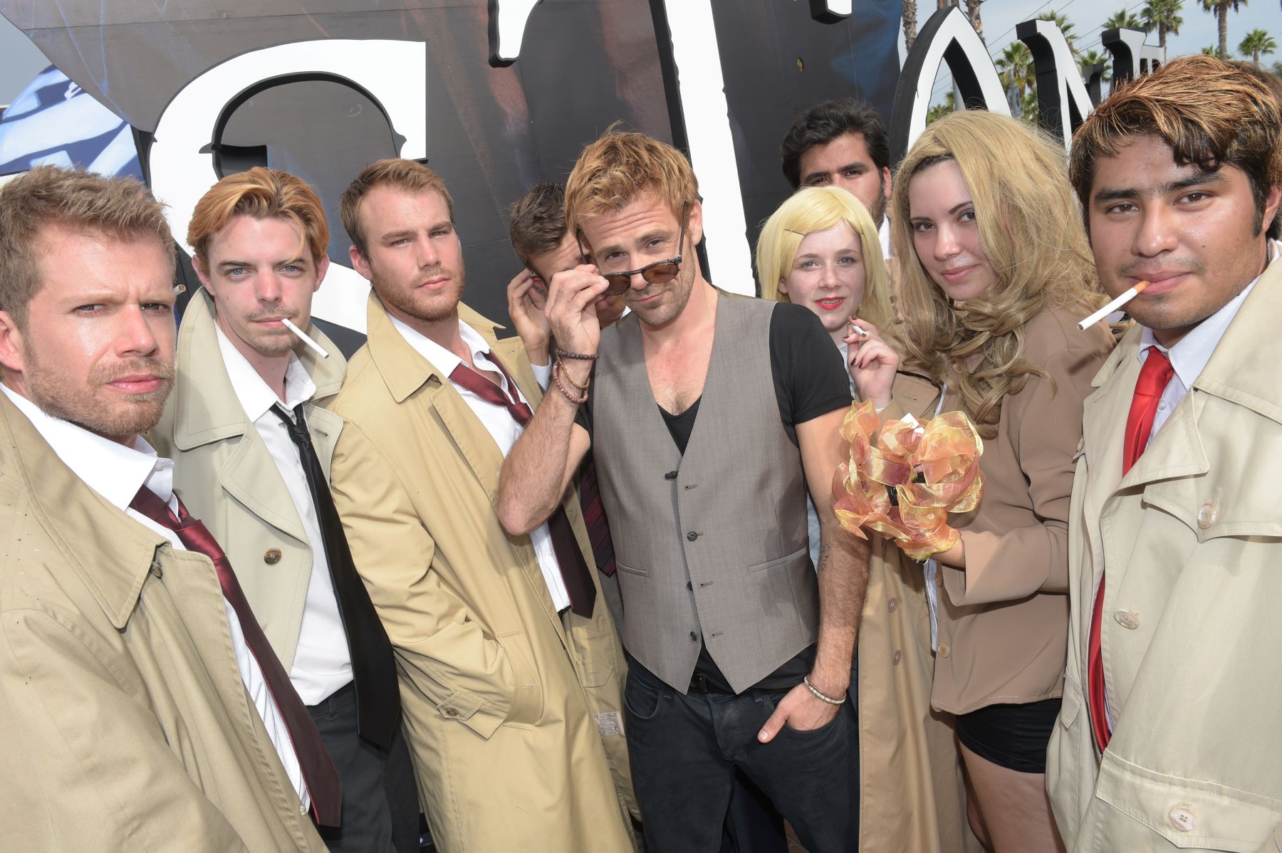 Matt Ryan poses with fans dressed like John Constantine at San Diego Comic-Con.
