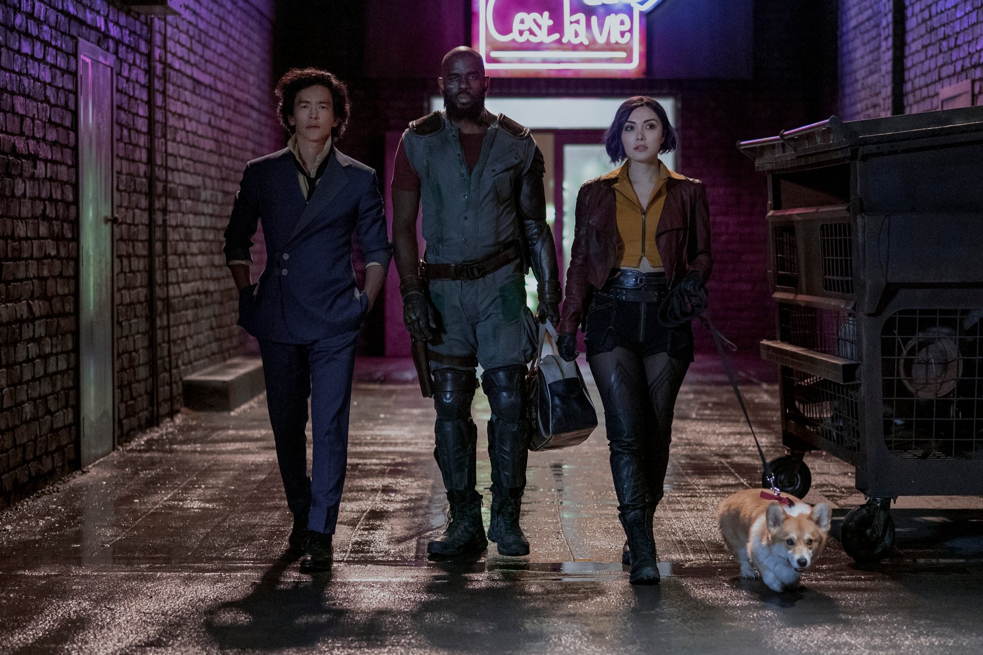 John Cho, Mustafa Shakir, and Daniella Pineda in Netflix's live-action 'Cowboy Bebop.' The three are walking next to one another, with Ein the corgi/alien next to them. Fans are wondering if the 'Cowboy Bebop' adaptation will feature Ed as well.