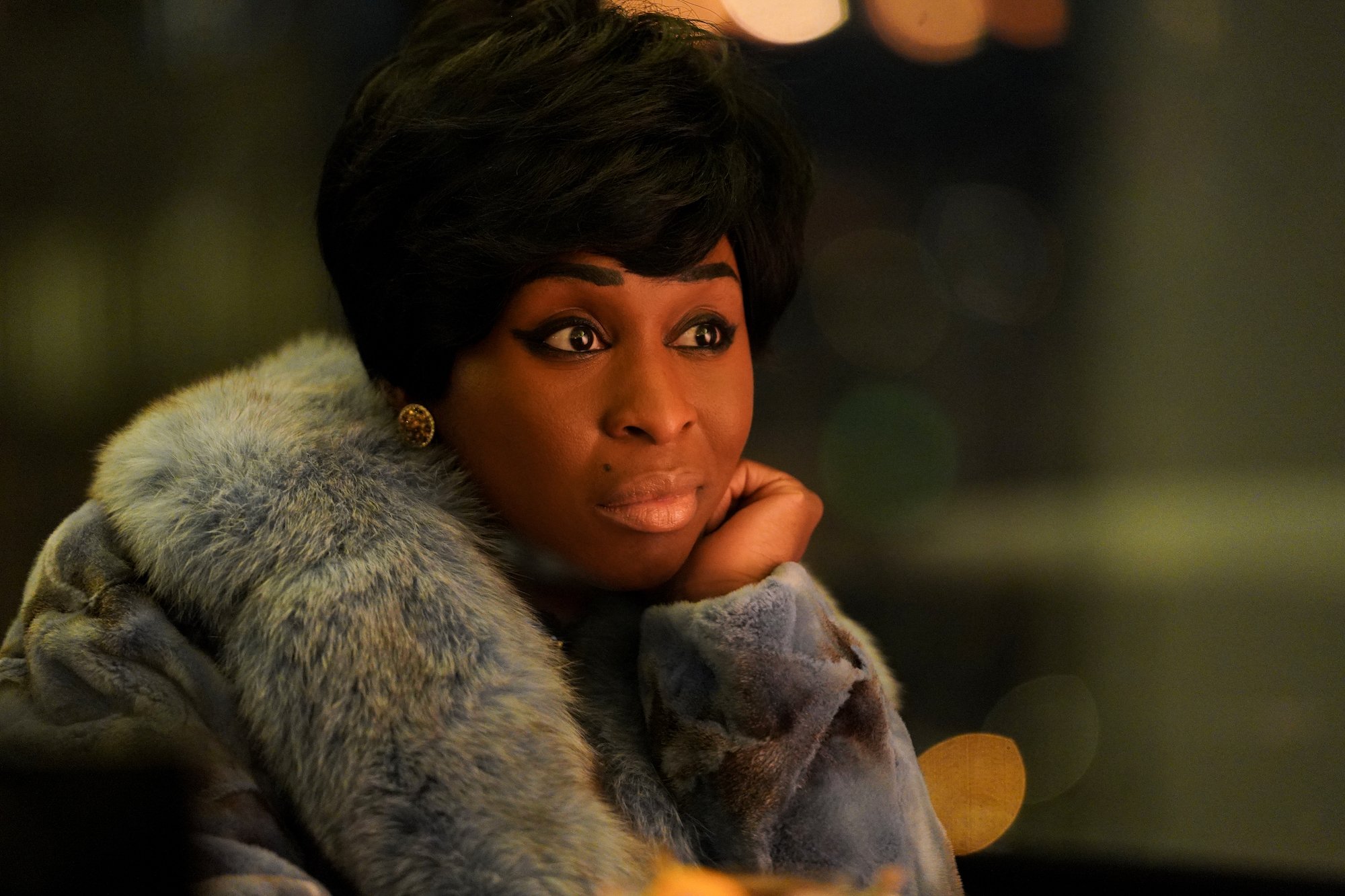 Cynthia Erivo sitting down with her hand on her cheek in 'Genius: Aretha.'