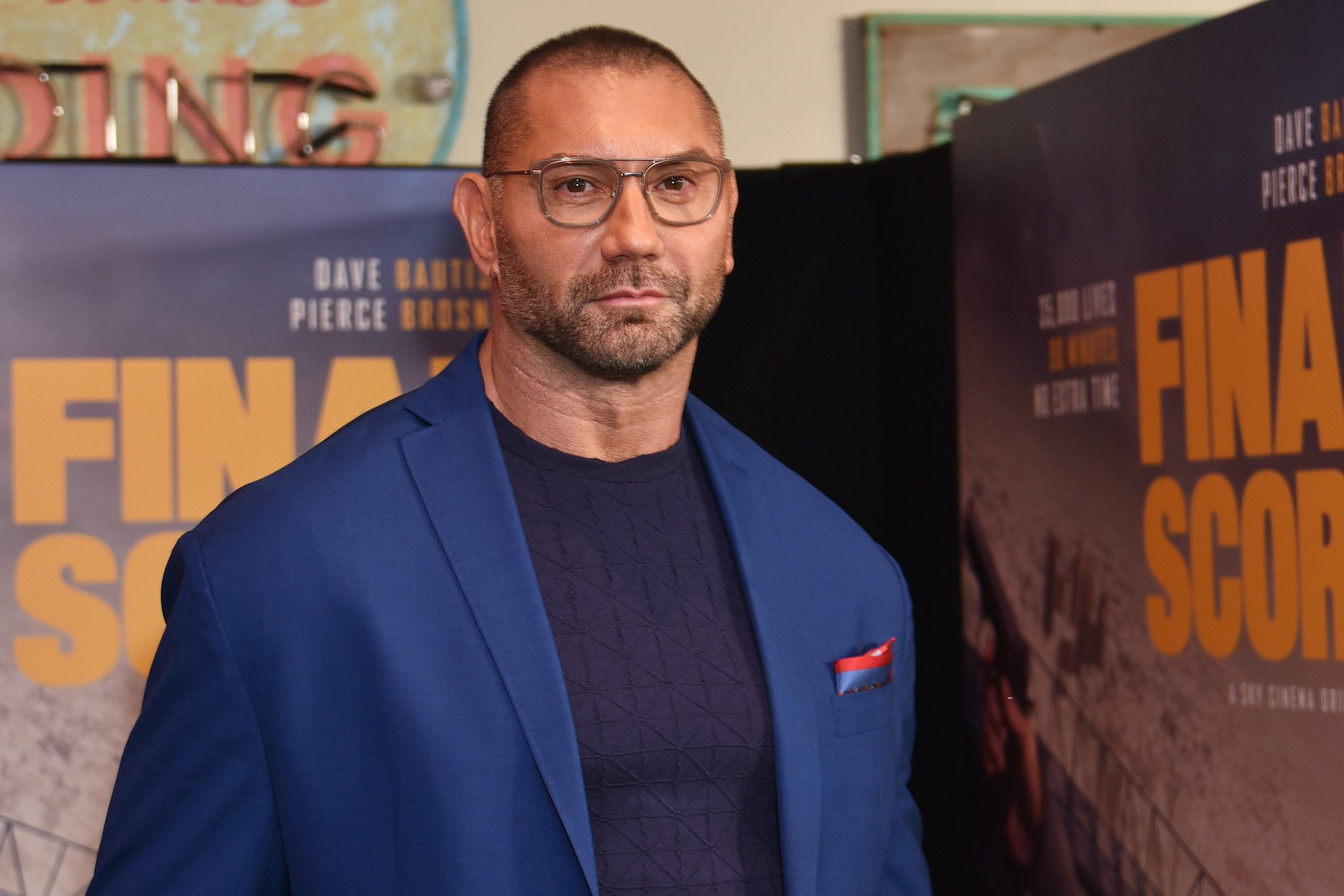 Dave Bautista smiling in front of a blurred background