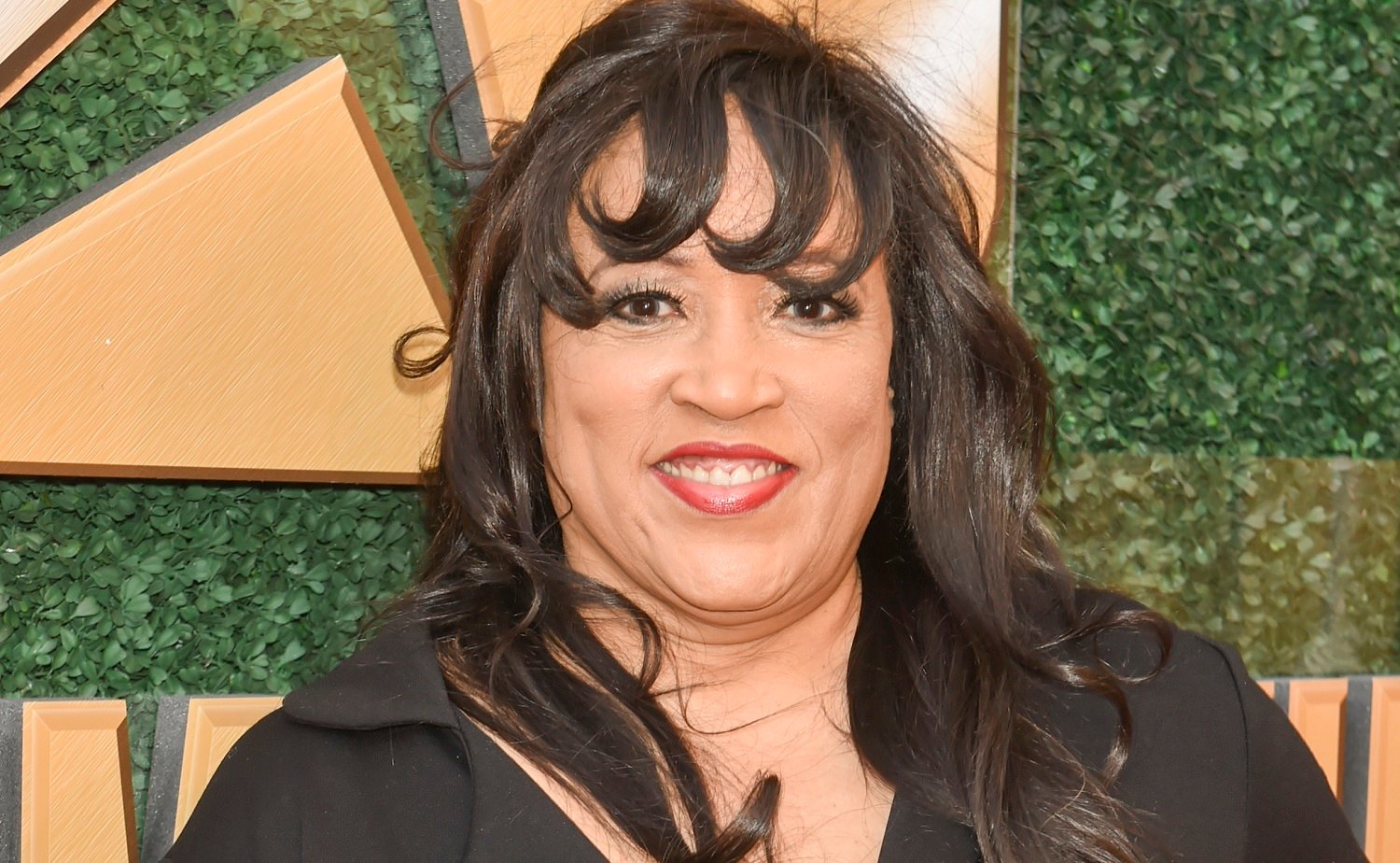 Days of Our Lives speculation focuses on Jackée Harry, pictured in a black blouse against a grass backdrop