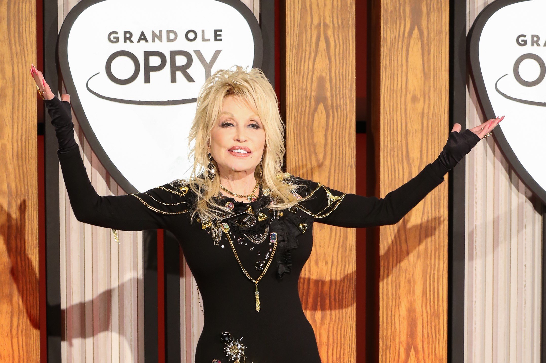 Dolly Parton in a black dress. She shared the secret to her long marriage.