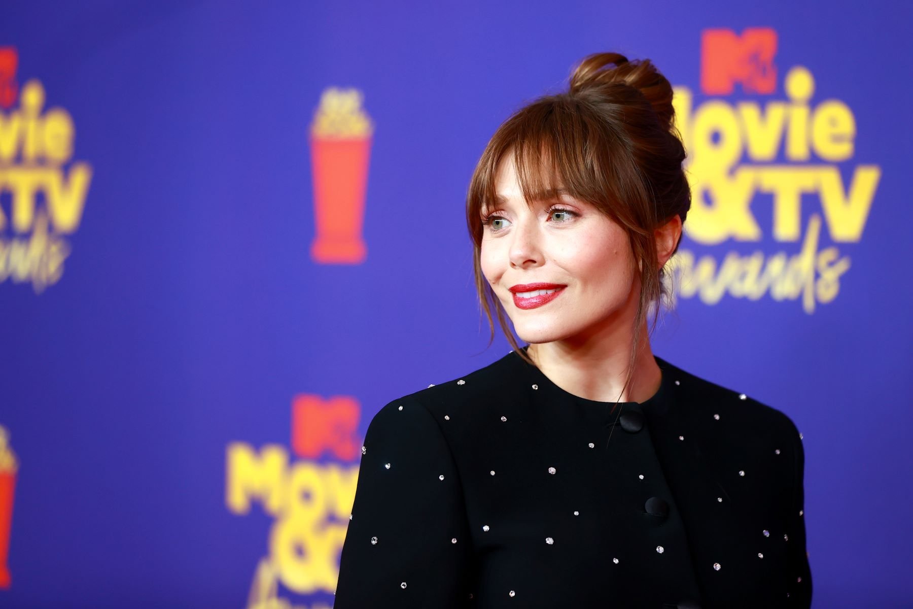 Elizabeth Olsen, star of 'Doctor Strange in the Multiverse of Madness,' poses for pictures at the 2021 MTV Movie & TV Awards.