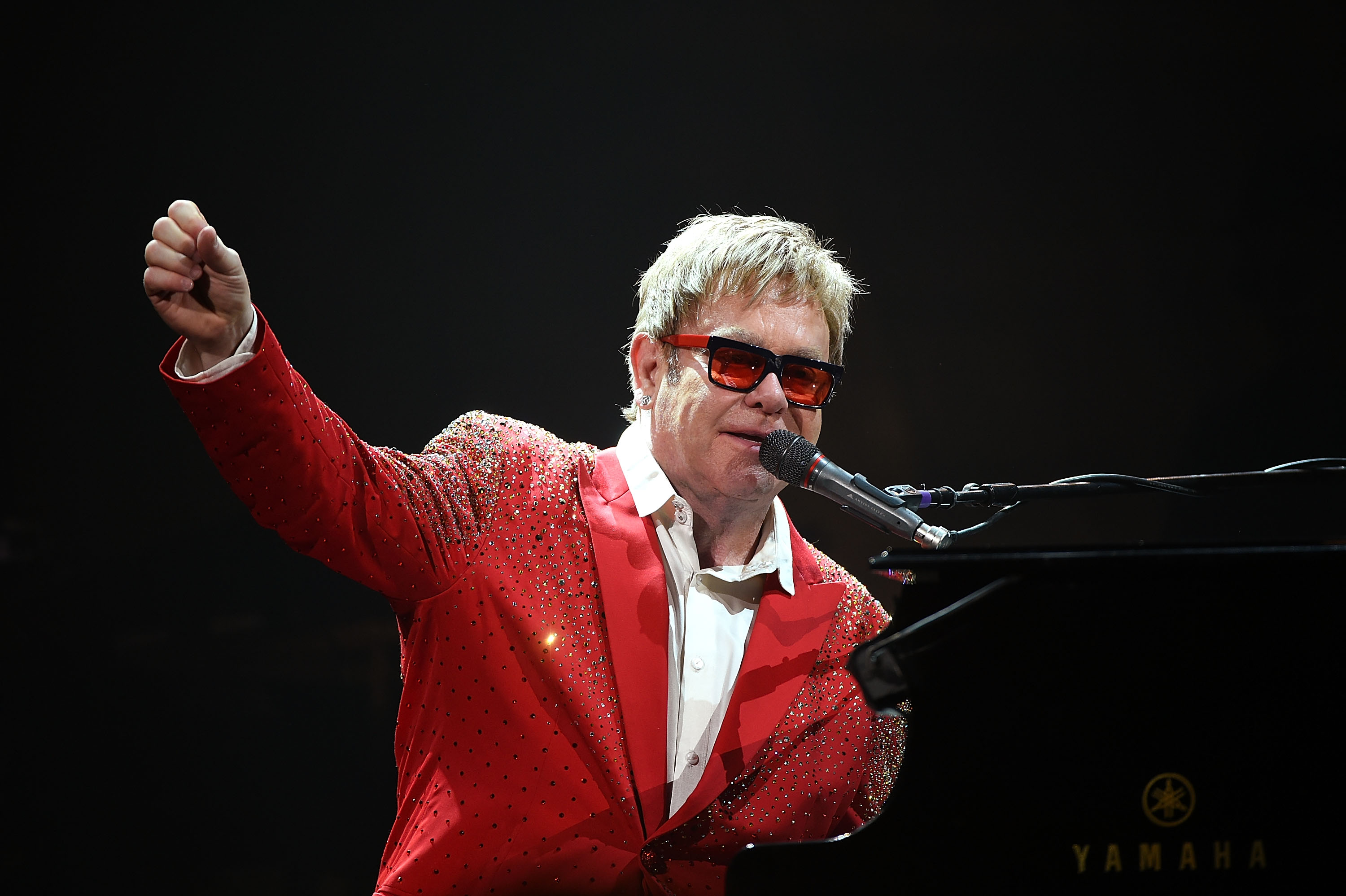 Elton John character from Rocketman singing onstage