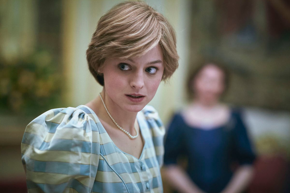 Emmy nominee Emma Corrin as Princess Diana wears a dress and looks to the side in 'The Crown'