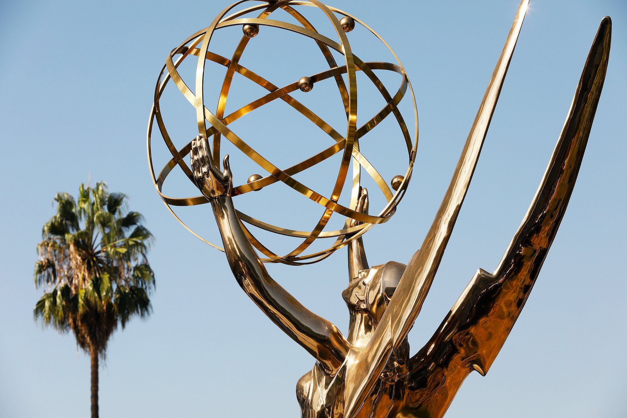 The Emmy Award statue with a palm tree in the background at the Academy of Television Arts & Sciences campus in Los Angeles