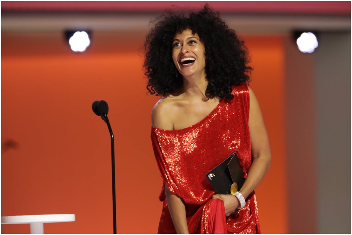 Emmys 2021 nominee Tracee Ellis Ross smiling while presenting an award on the stage.