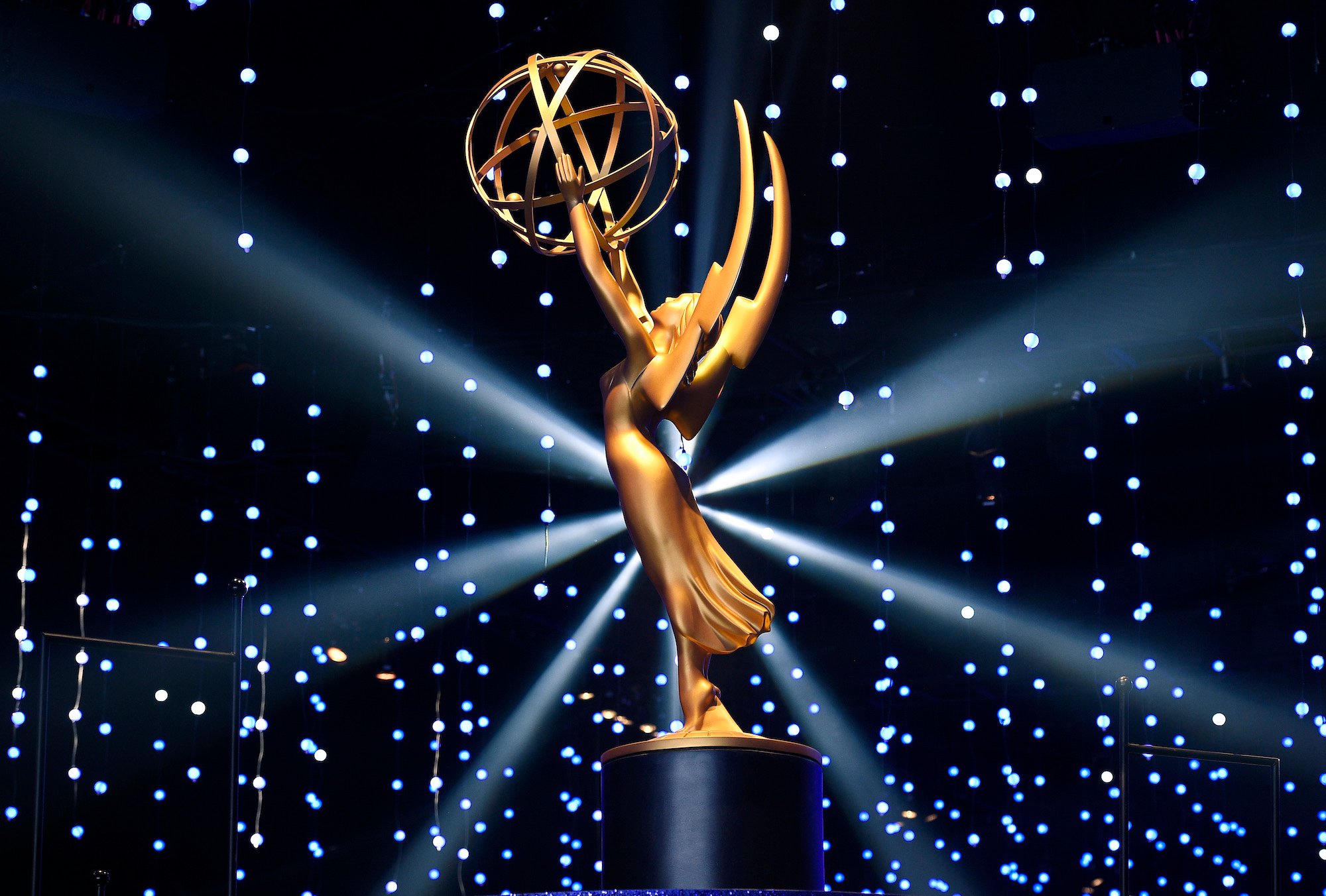 Large model of the statuette of the Emmy Award illuminated on a stage