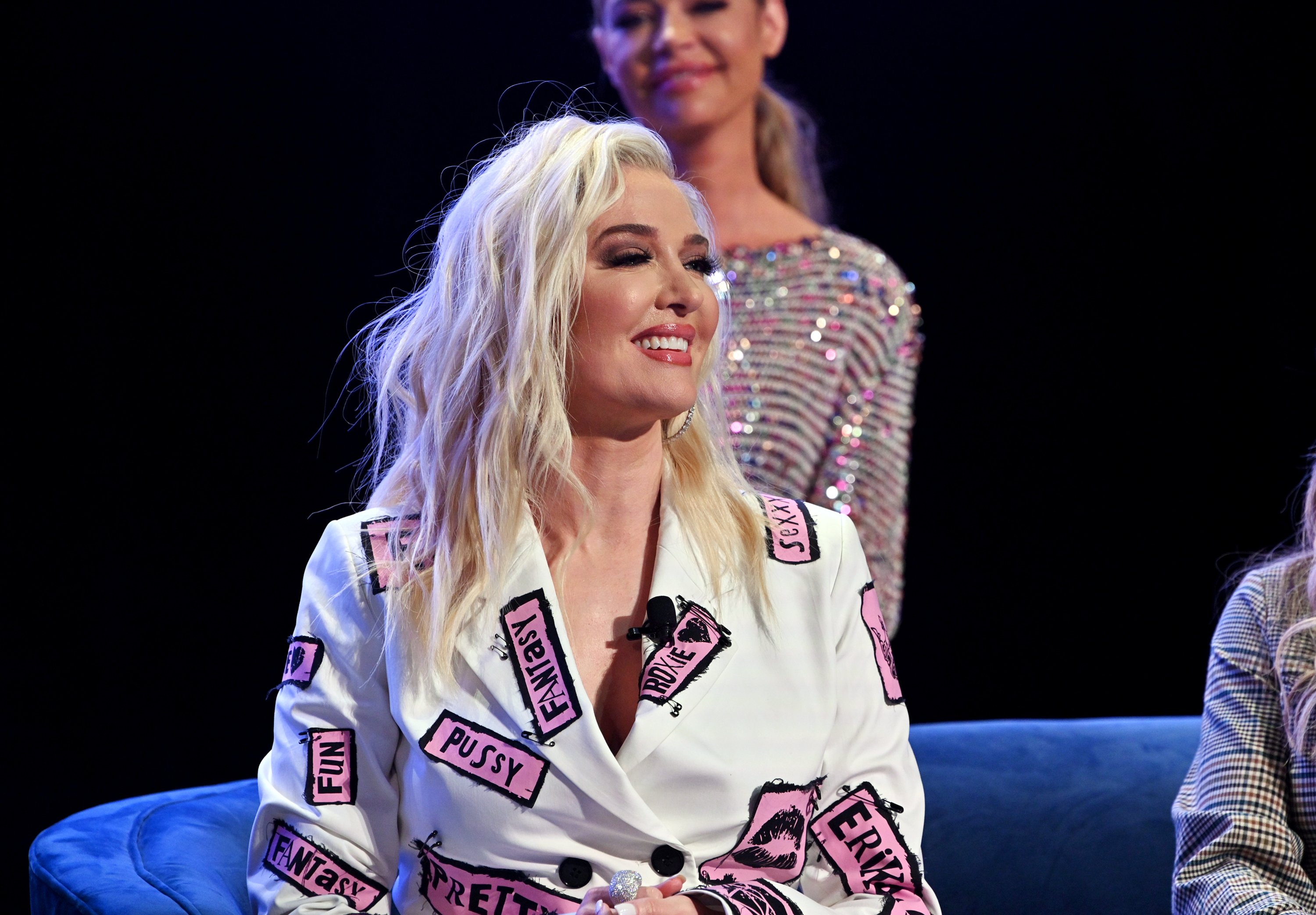 Erika Jayne Girardi smiling and laughing at BravoCon on the 'RHOBH' panel.