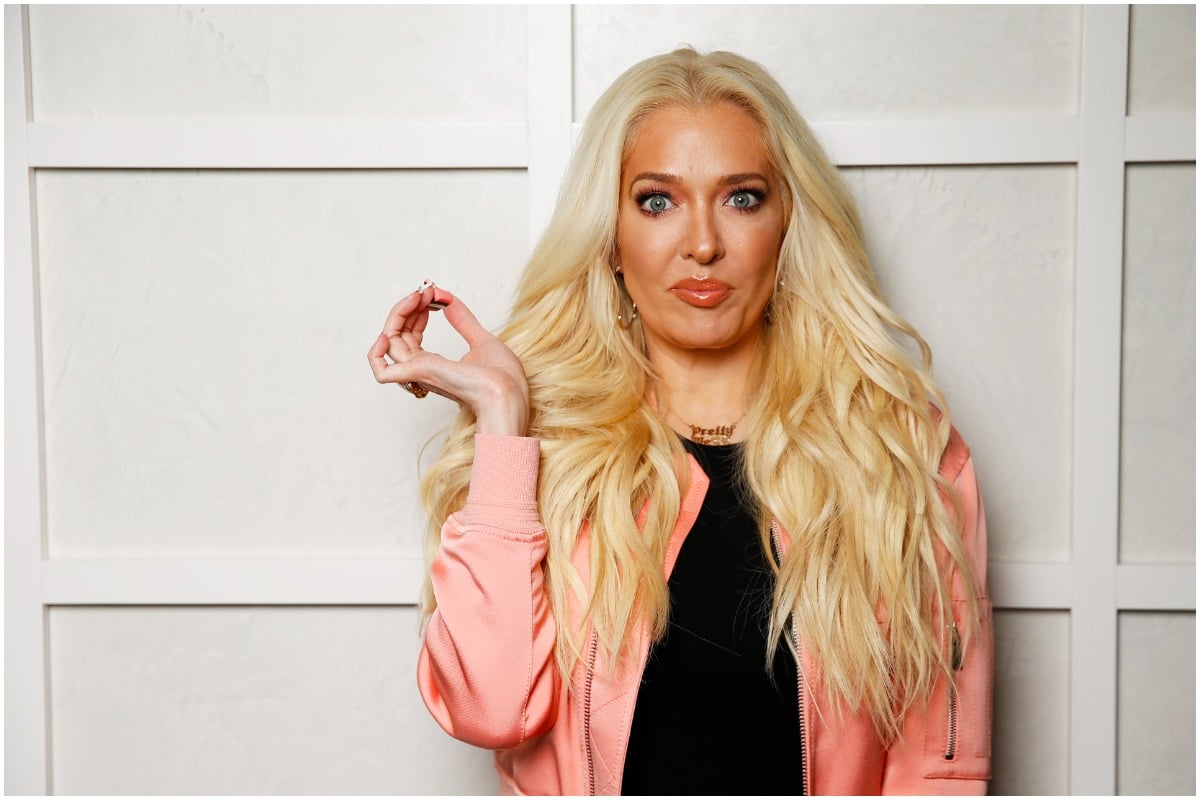 Erika Jayne from 'RHOBH' holding a piece of candy at a promotional photo shoot.