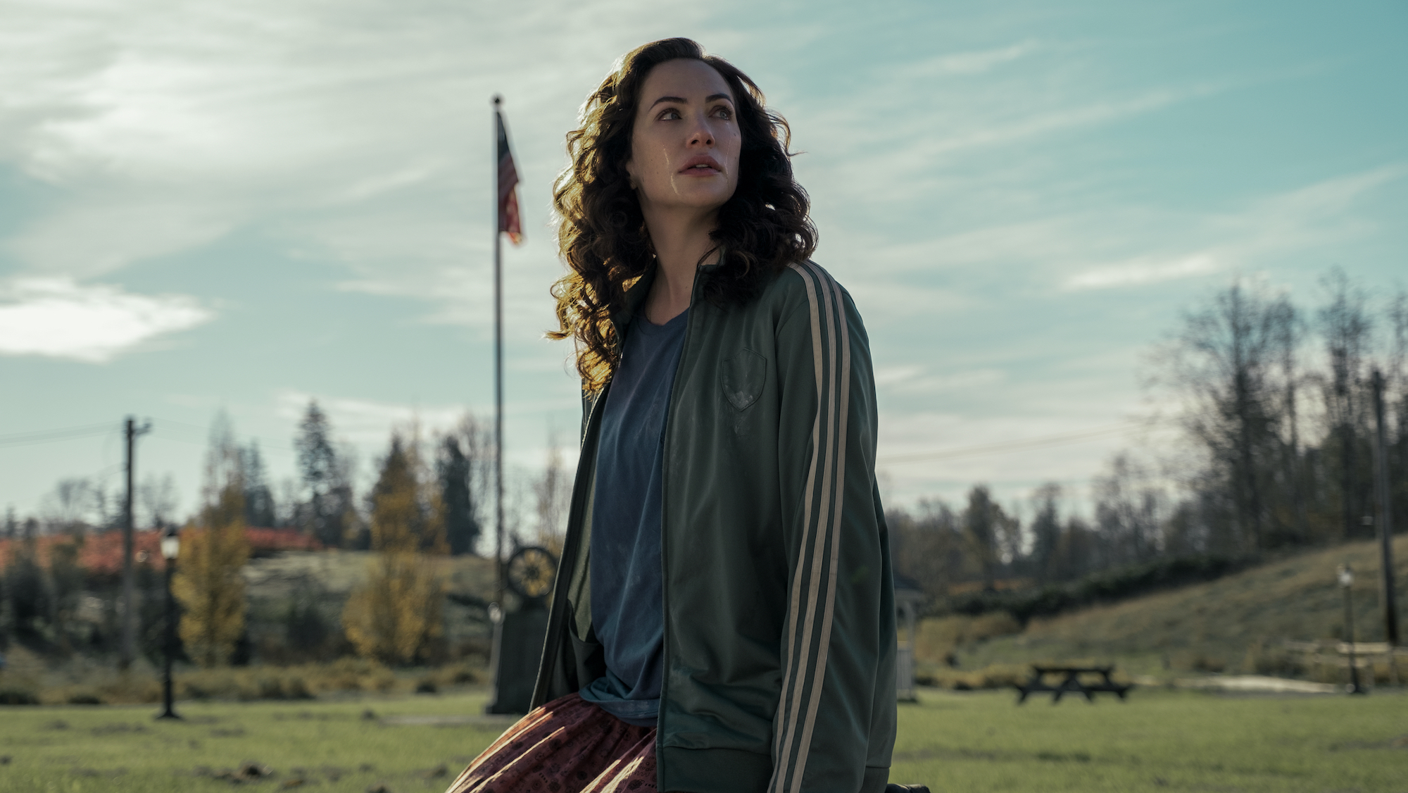 Kate Siegel as Erin Green looking over her shoulder in the town of Crocket Island from the Netflix series 'Midnight Mass'