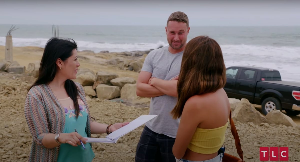 Evelin Villegas and Corey Rathgeber on the beach with wedding planner Carolina Muzo in 