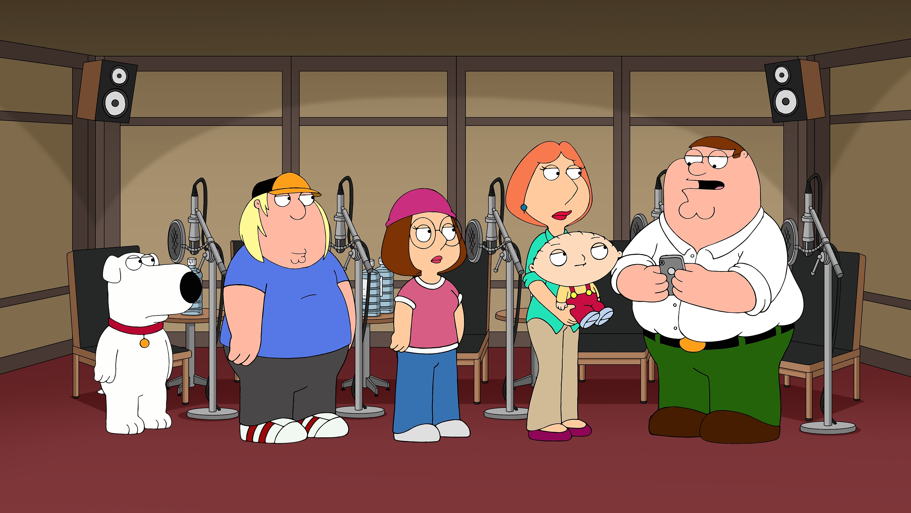 A 'Family Guy' scene featuring the Griffin family in a recording booth from the show's 16th season.