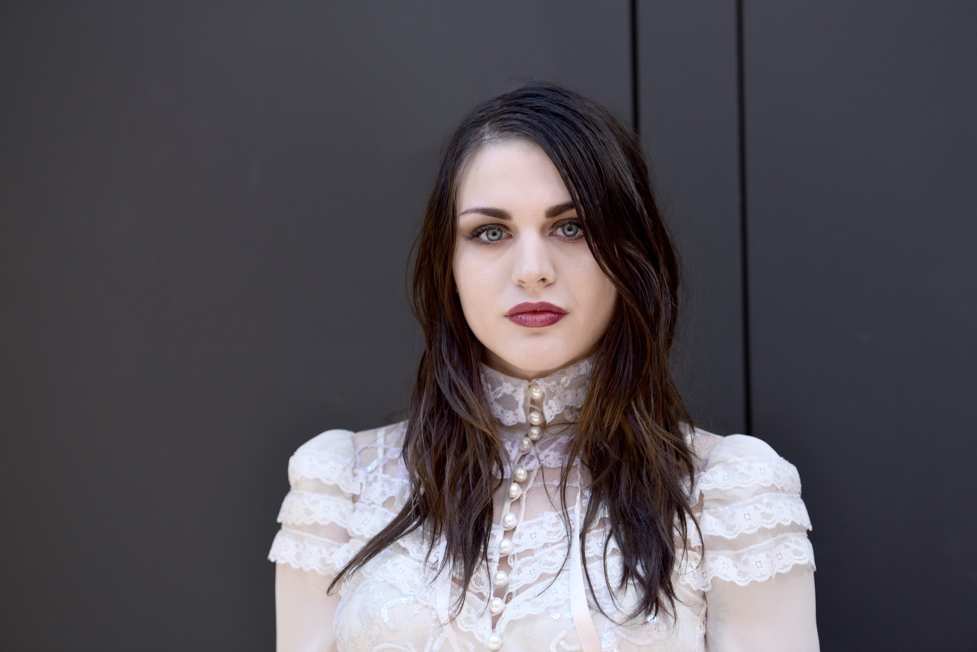 Frances Bean Cobain in front of a gray background