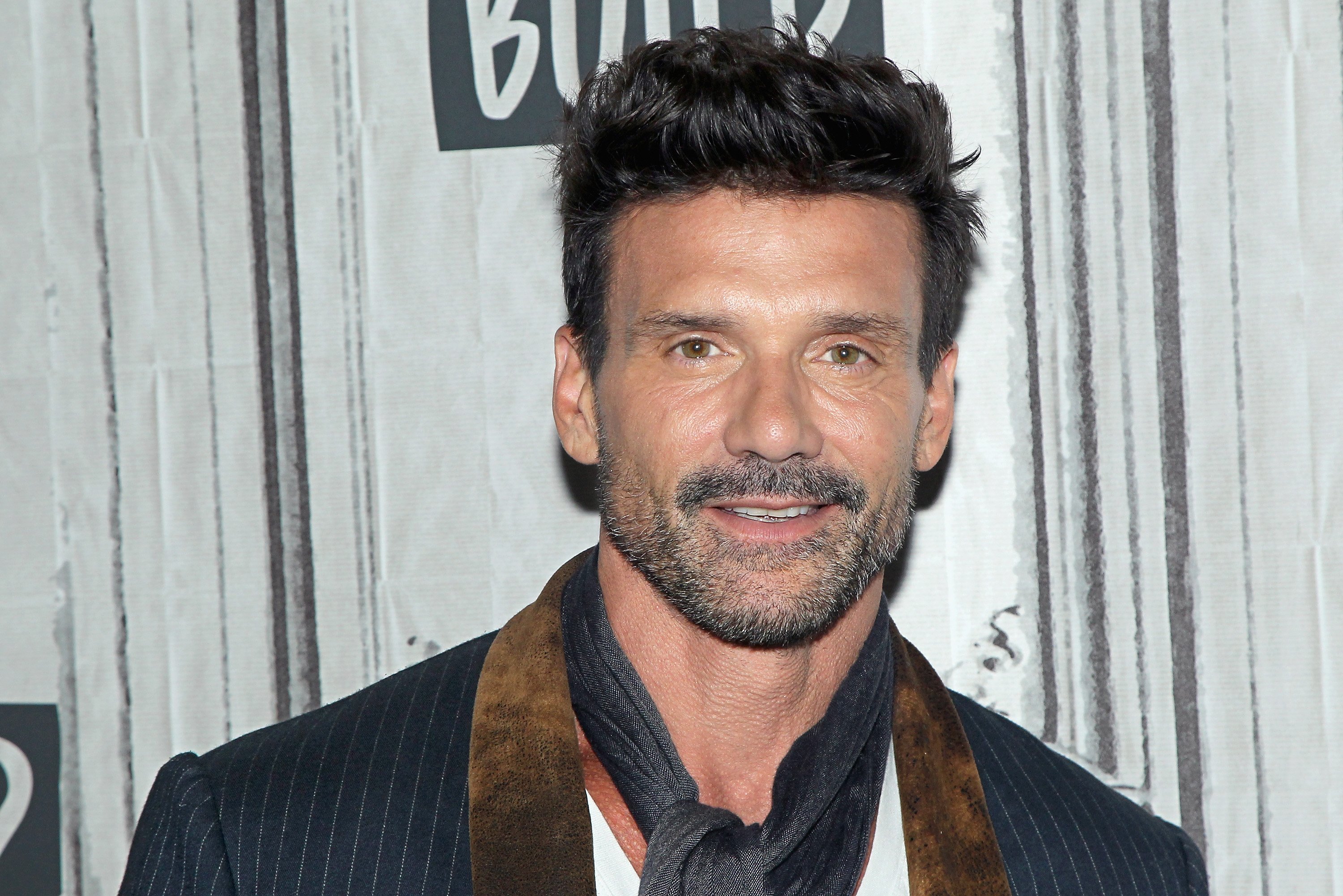 Frank Grillo, in a black jacket and black scarf, at an event in 2018.