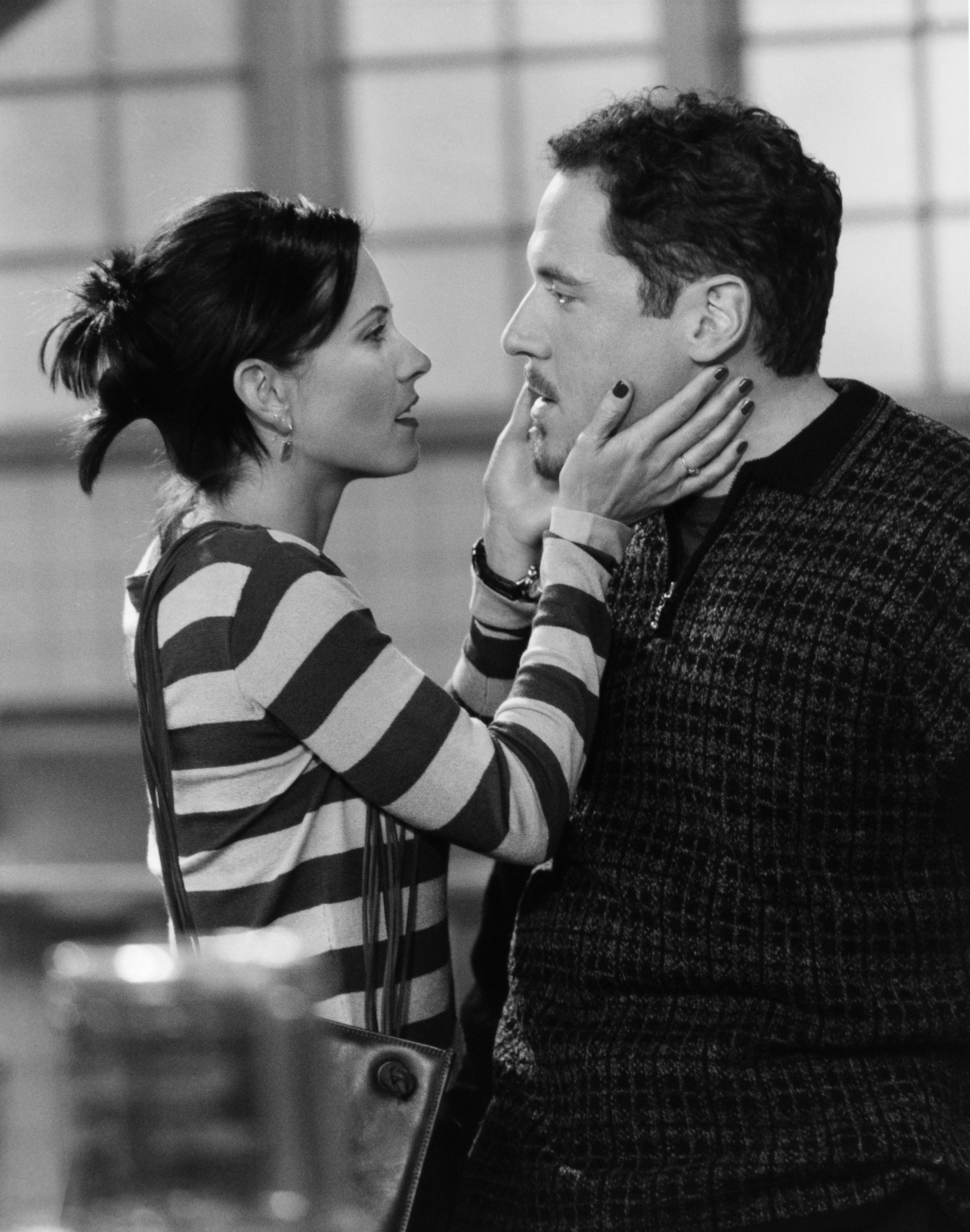 Monica Geller and Pete Becker embrace in an industrial kitchen during season 3 of 'Friends'
