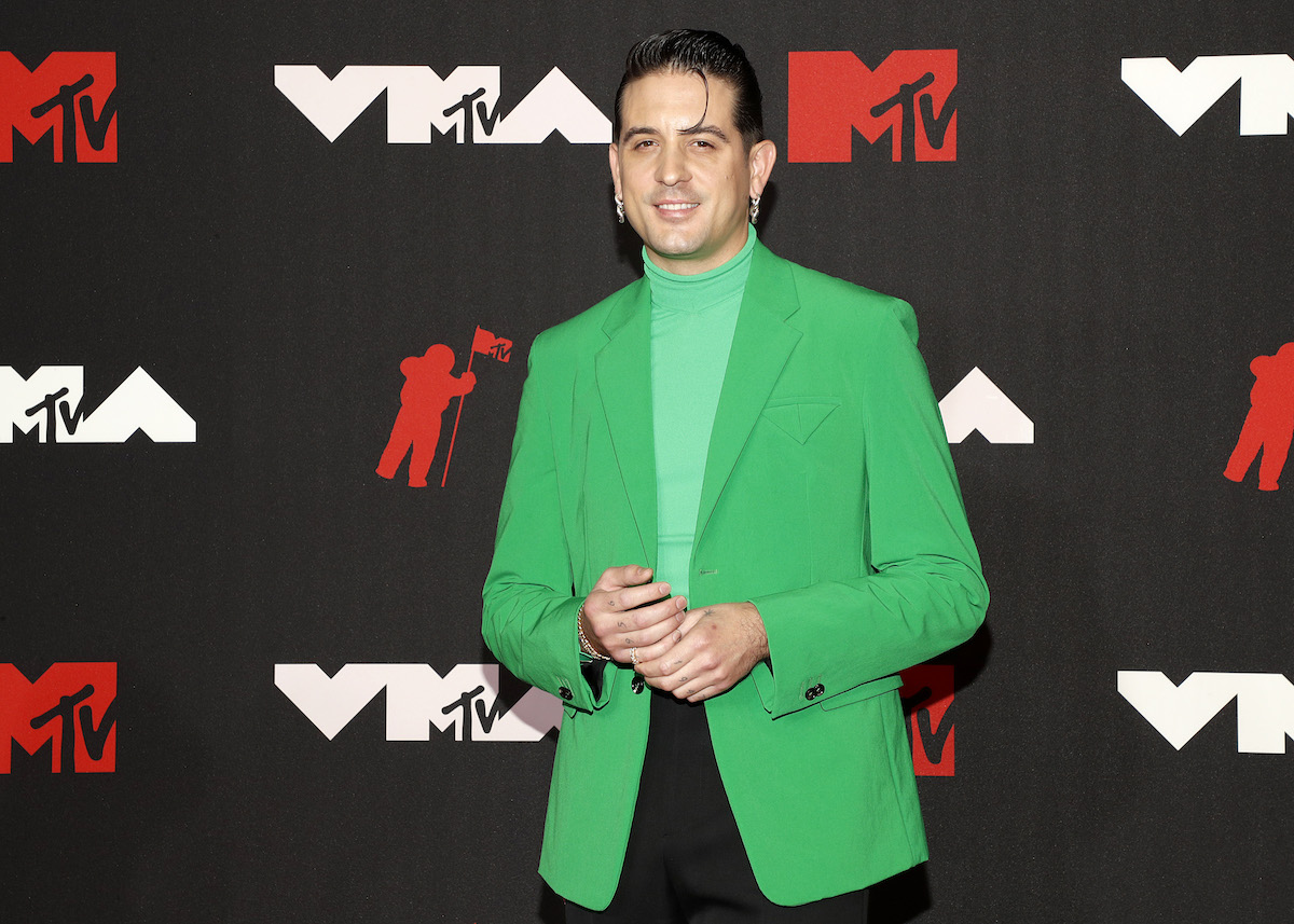 G-Eazy wearing a bright green jacket and matching turtleneck at the 2021 VMAs.