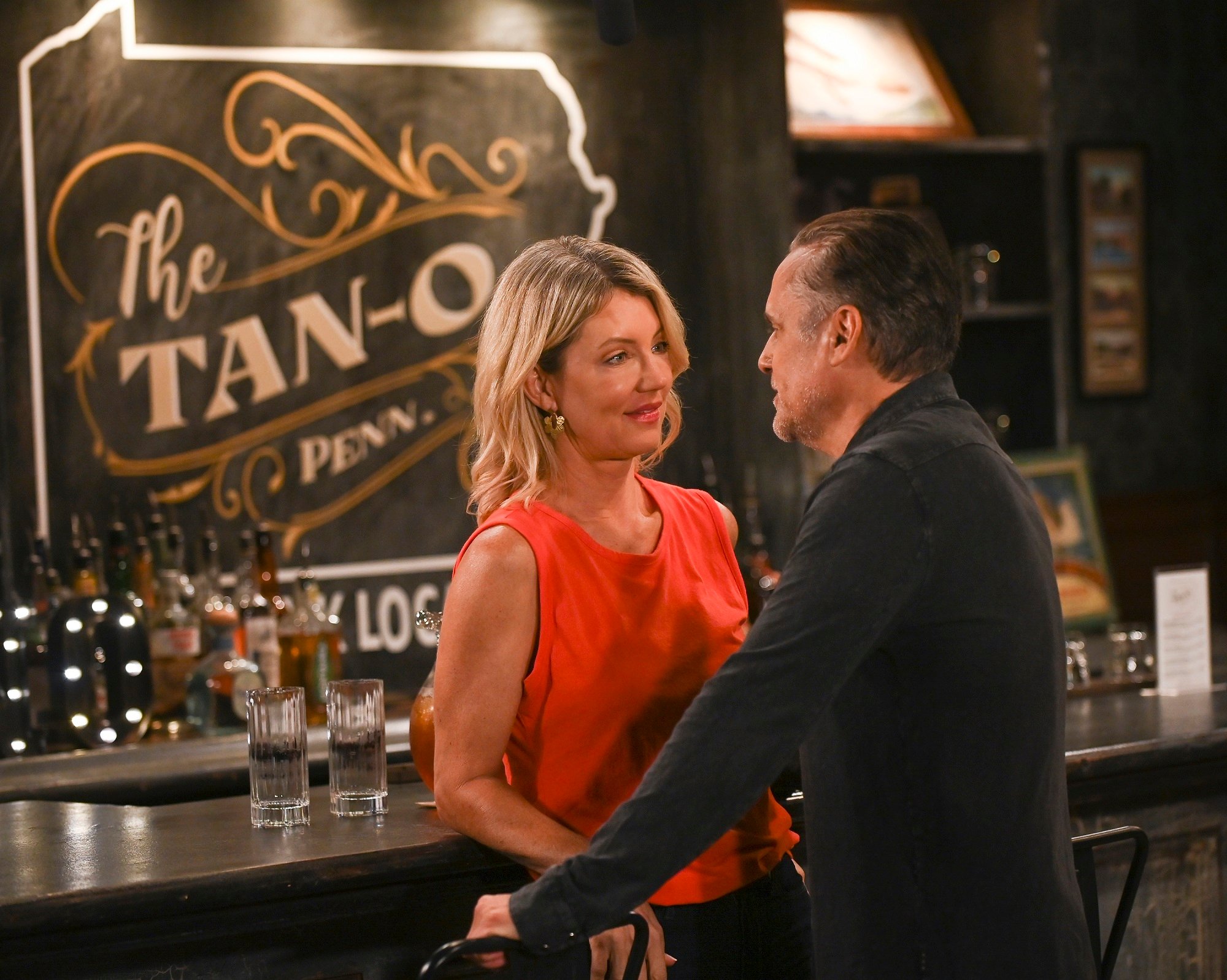 General Hospital speculation focuses on Nina, pictured here leaning against a bar in a red short-sleeved shirt