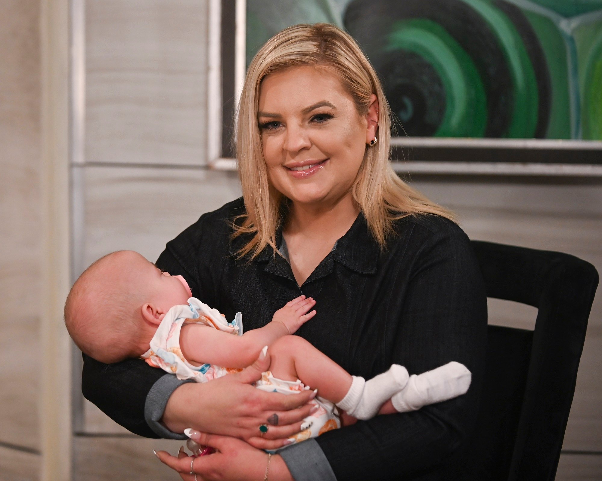 General Hospital speculation focuses on Maxie, pictured here in black and holding a baby