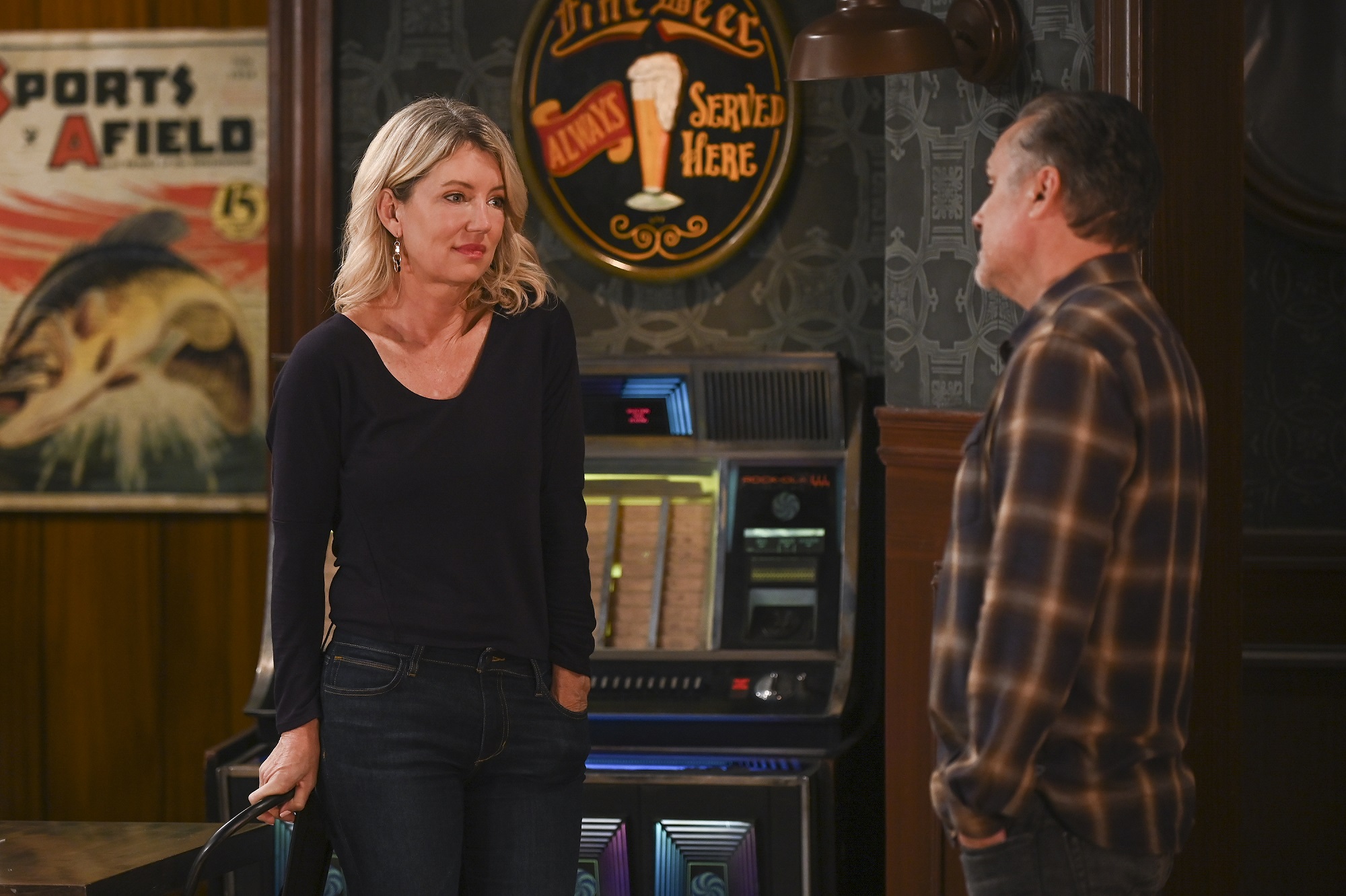 General Hospital speculation focuses on Nina, pictured here in a black shirt with a pair of blue jeans, with a jukebox in the back