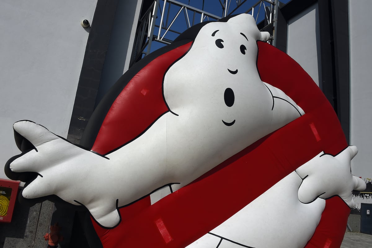 The 'Ghostbusters' logo with a white ghost peeking through a red circle.