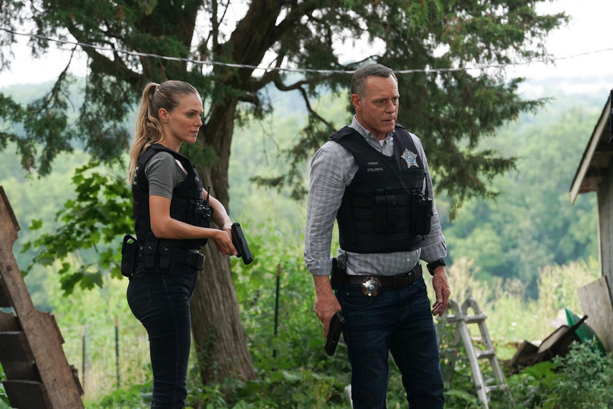 Hailey Upton and Hank Voight standing outside holding guns in 'Chicago P.D.' Season 9
