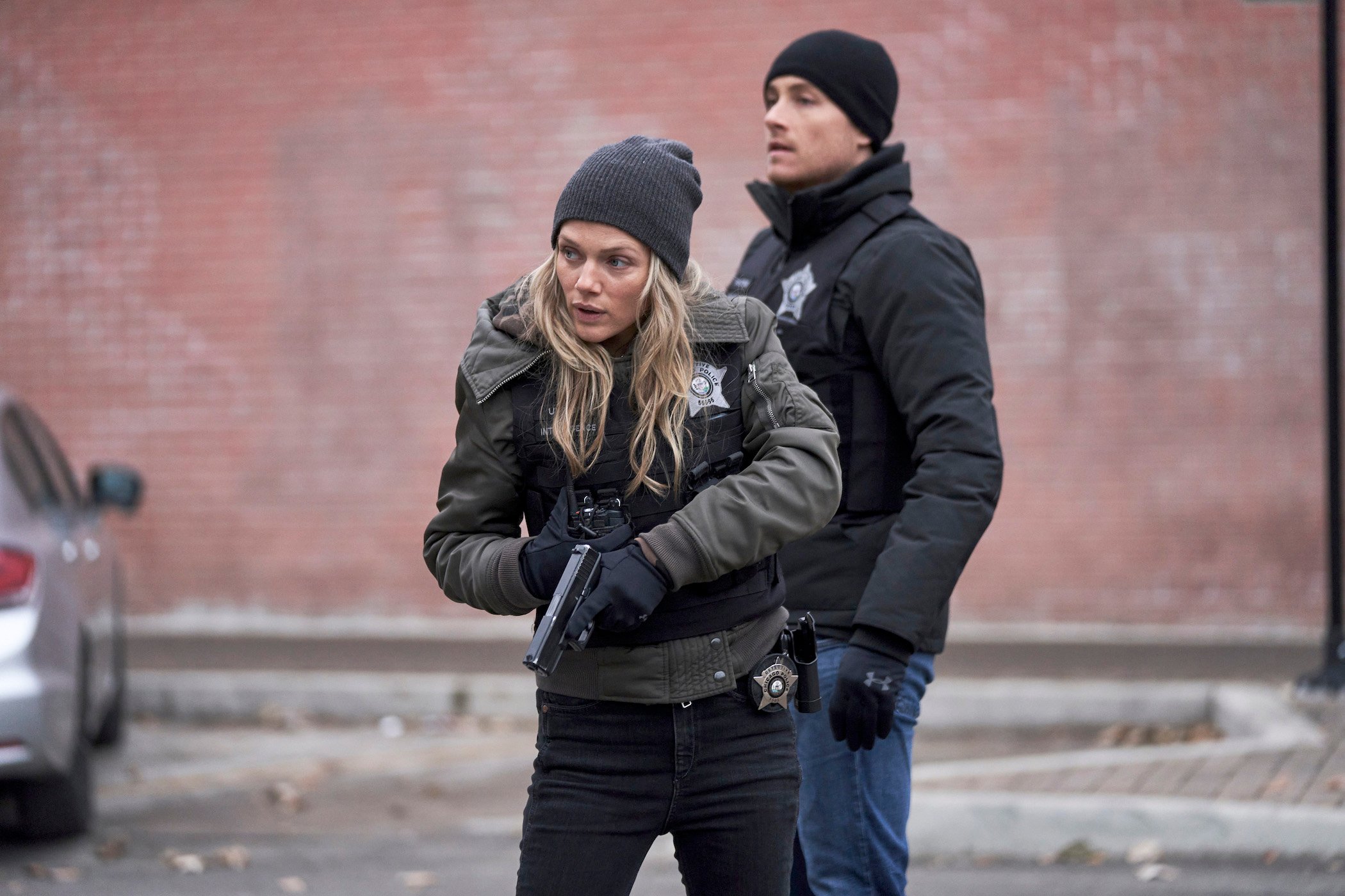 Jay Halstead behind Hailey Upton while she's holding a gun in 'Chicago P.D.' Jay Halstead and Hailey Upton get engaged in 'Chicago P.D.' Season 9