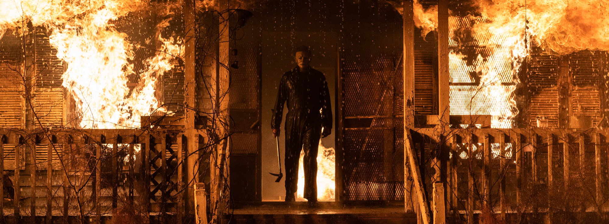 'Halloween Kills' horror slasher Michael Myers escaping from a house on fire with a weapon