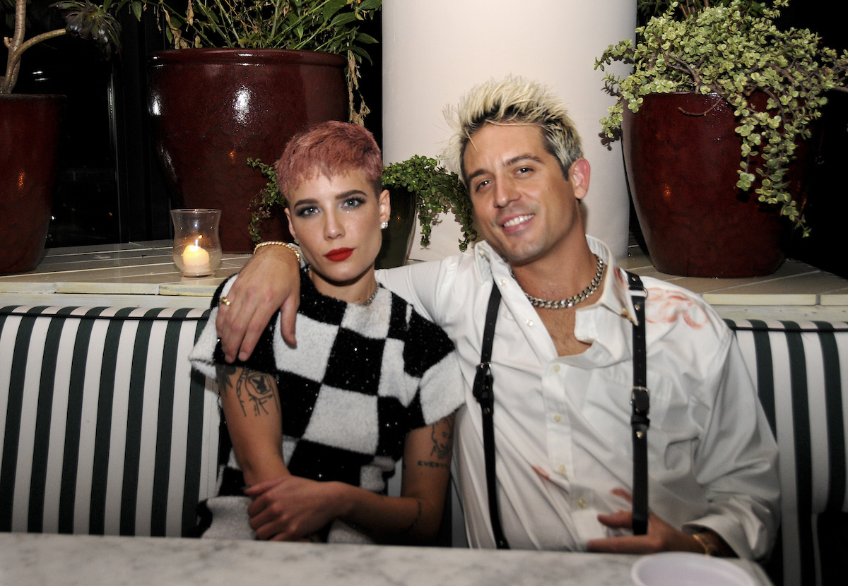 Halsey and G-Eazy pose together at an event wearing matching black and white outfits.