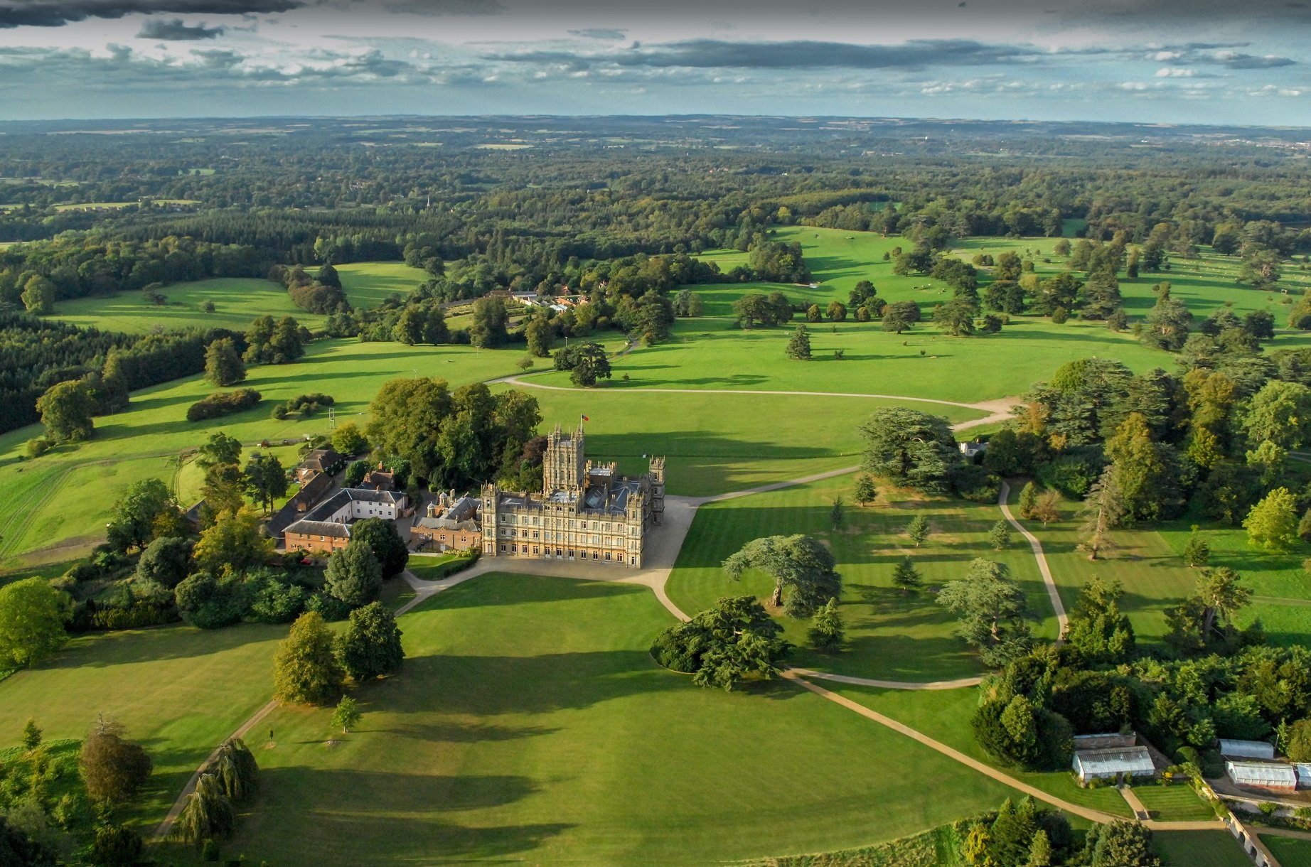 An aerial photograph of Highclere Castle in Hampshire, England serves as the set of 'Downton Abbey'