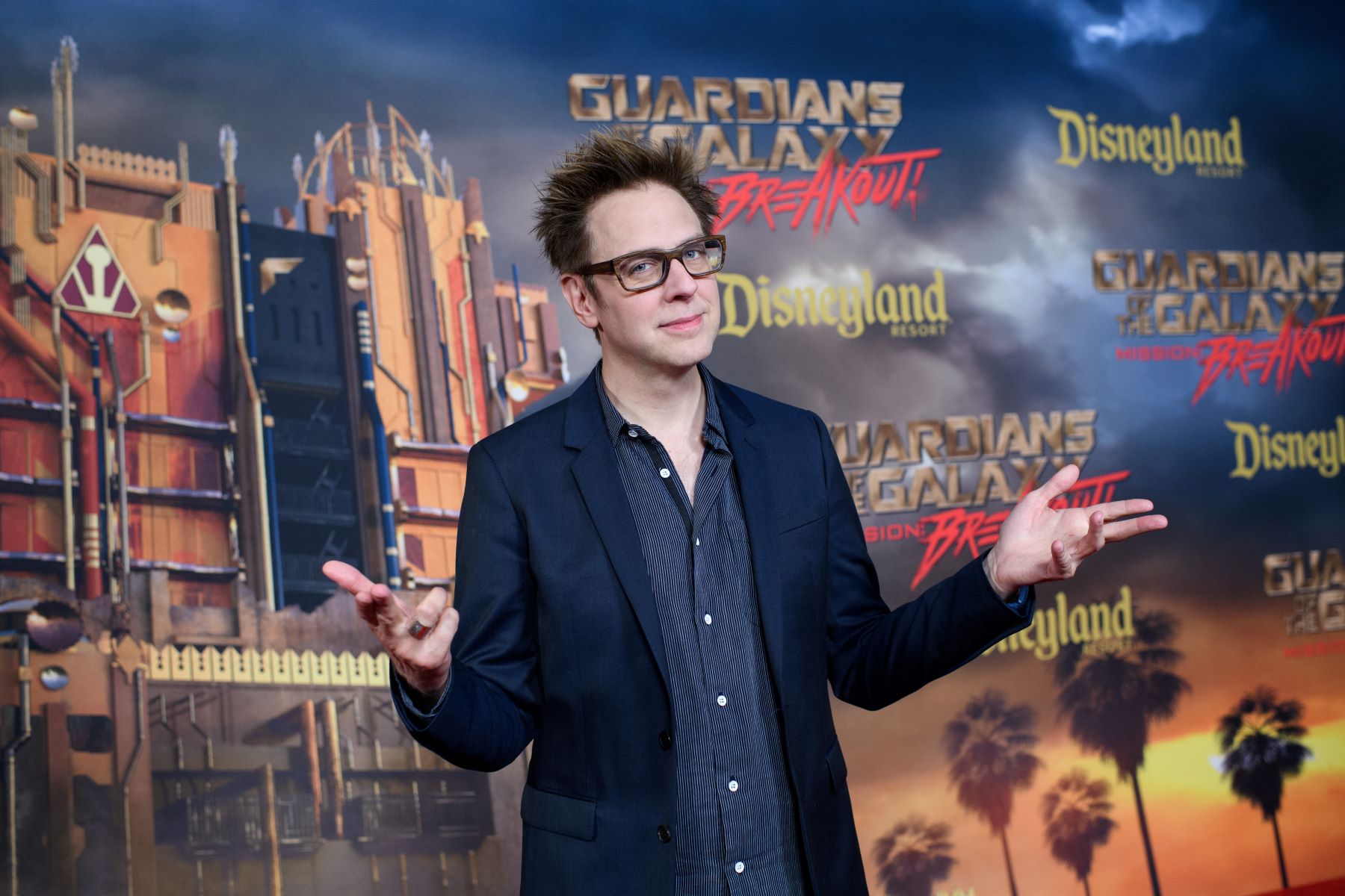 James Gunn, director of 'Guardians of the Galaxy' films, wears a casual suit and a pair of glasses at the opening of a ride at Disneyland.