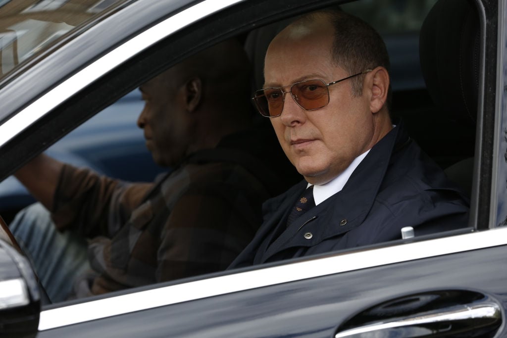 Hisham Tawfiq as Dembe Zuma, James Spader as Raymond 'Red' Reddington sit in a car.