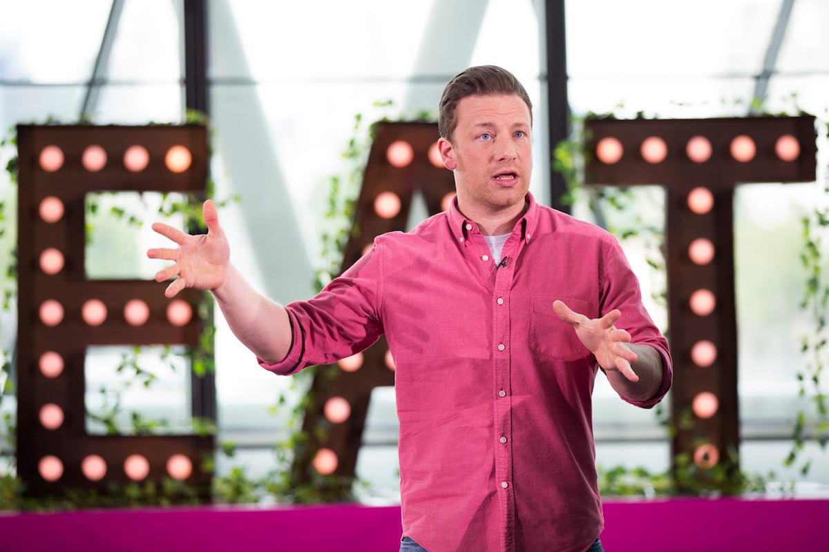 Jamie Oliver speaks while wearing a pink button down shirt during Jamie Oliver Presents Food Revolution Day in 2014