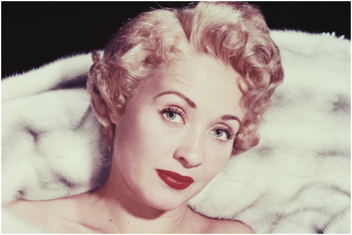 Actor Jane Powell smirking at the camera for a promotional photo shoot.
