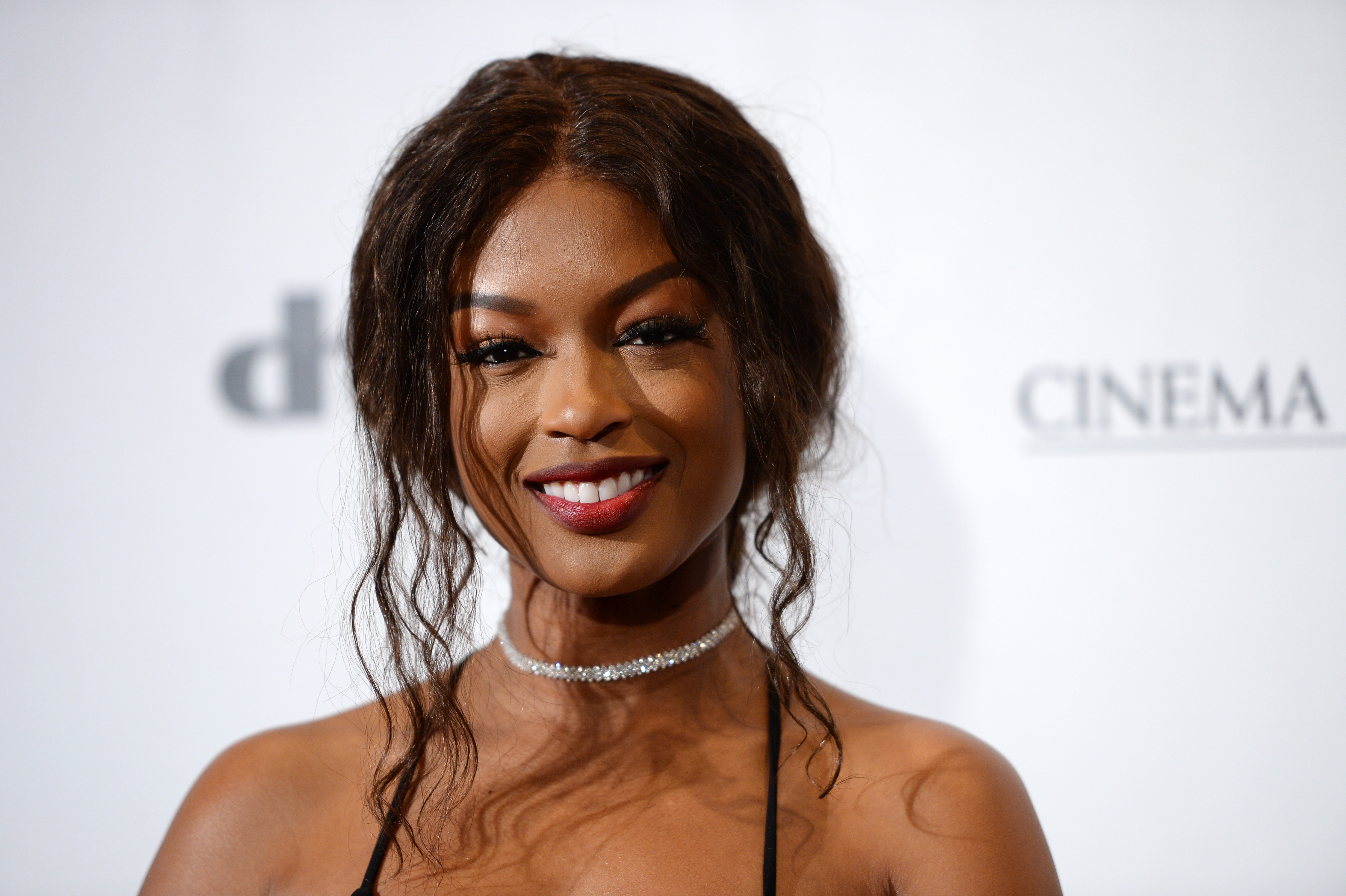 'Batwoman' actor Javicia Leslie wears a choker necklace and her hair up on the red carpet.