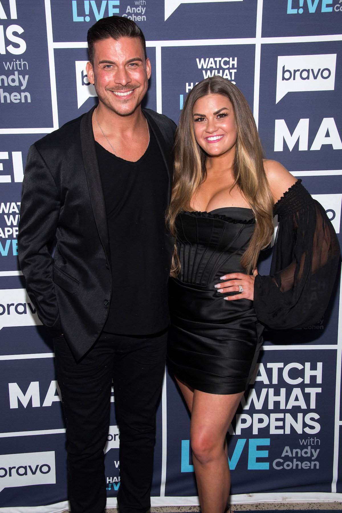 Jax Taylor and Brittany Cartwright, both wearing black, pose together at an event.