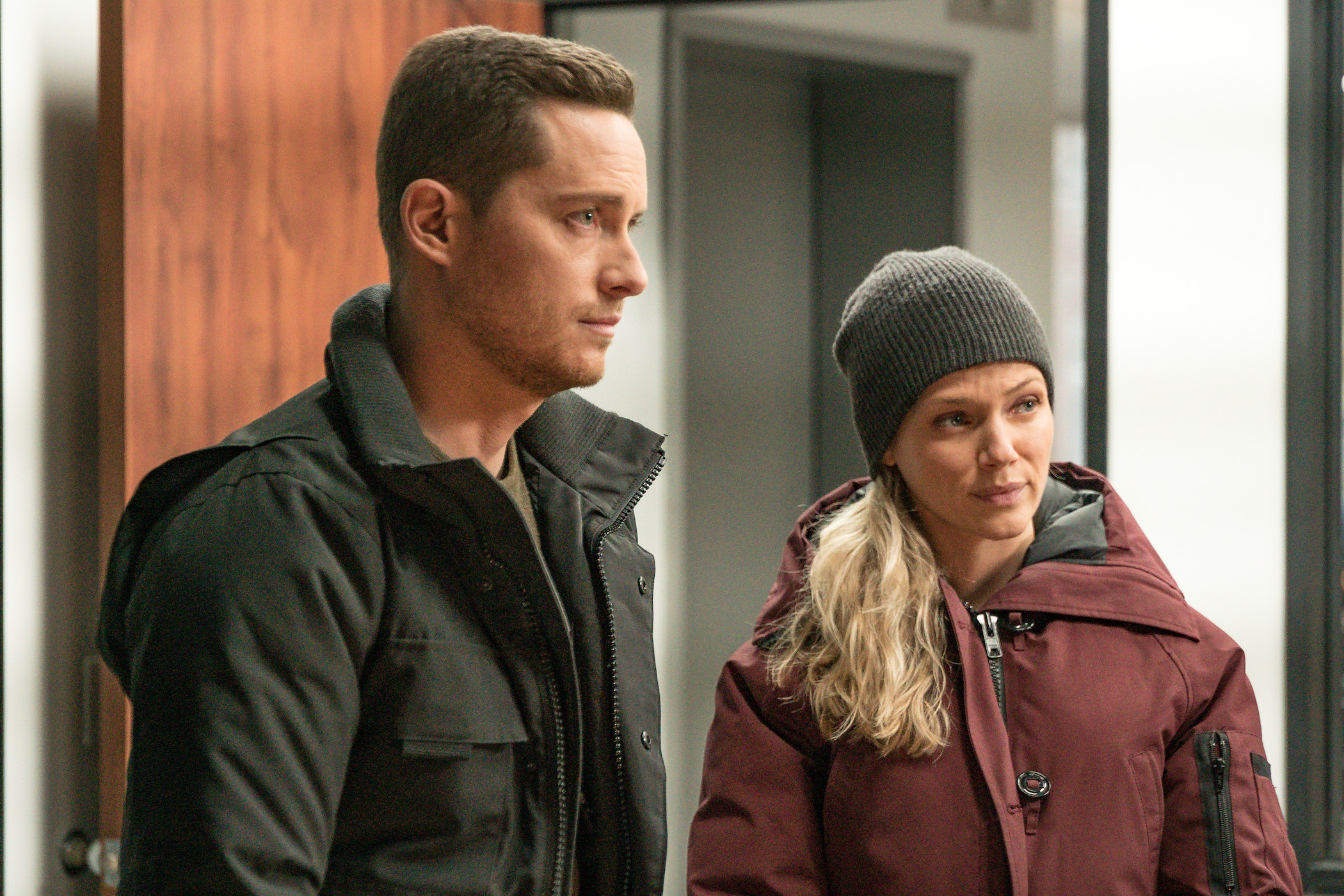 'Chicago P.D.' Season 9 stars Jesse Lee Soffer as Jay Halstead and Tracy Spiridakos as Hailey Upton standing next to each other. 'Chicago P.D.' Season 9 spoilers state they get engaged.