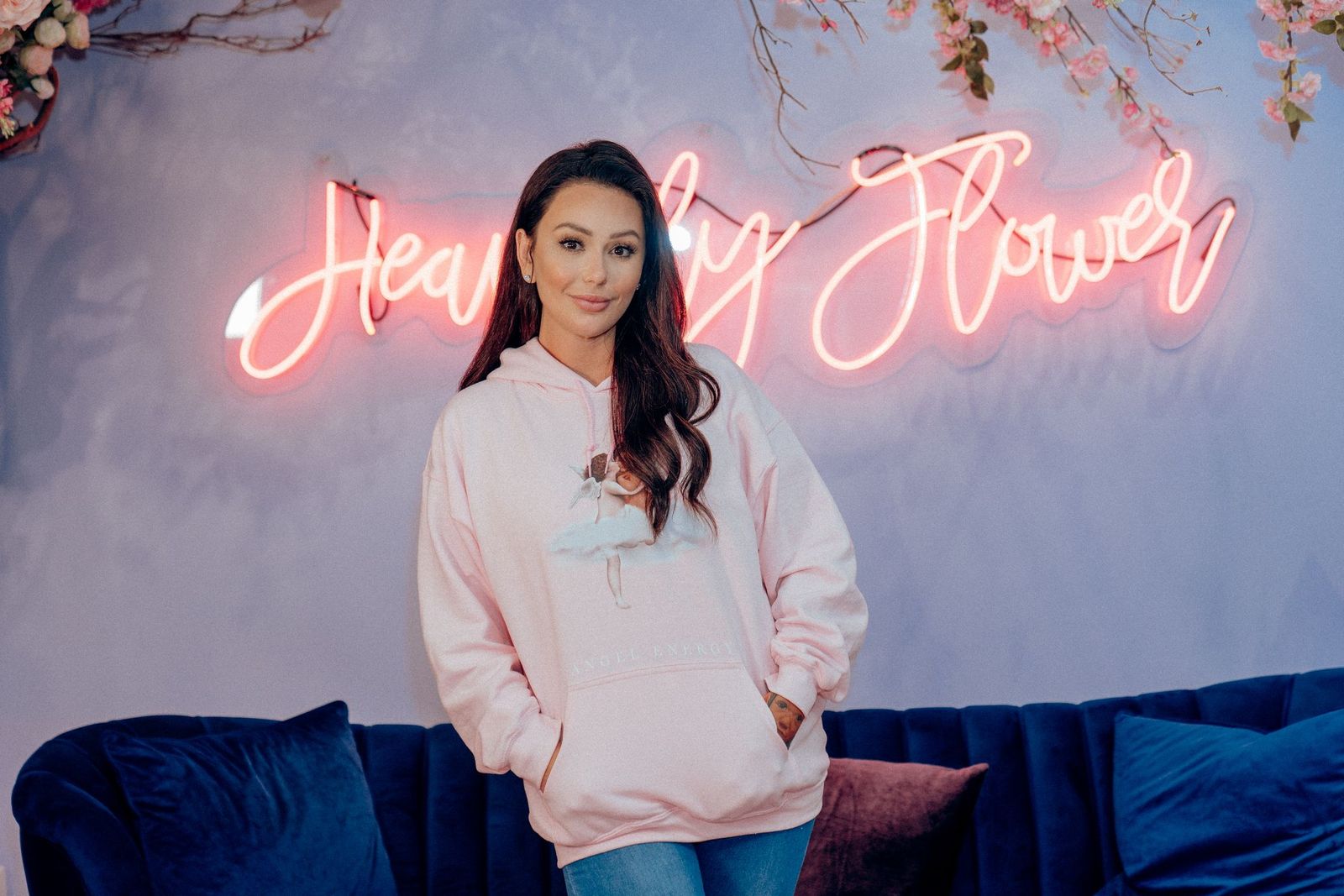 Jenni 'JWoww' Farley poses in front of the 'Heavenly Flower' neon lights in her store in the American Dream Mall