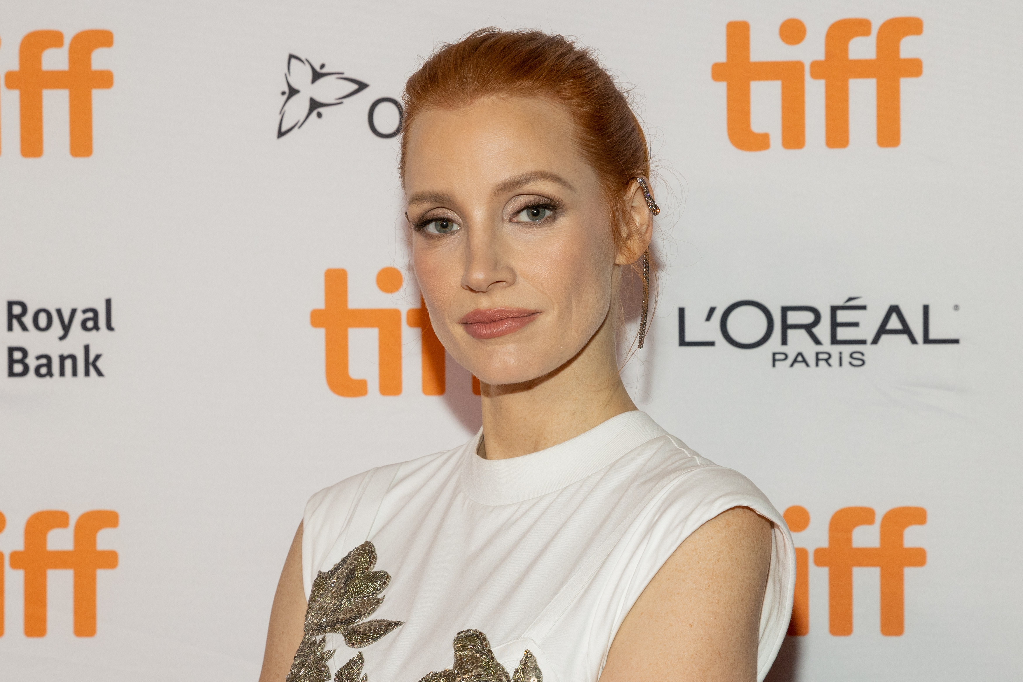 Jessica Chastain, in a white  dress with her hair tied in a bun, at the premiere of her movie 'The Eyes of Tammy Faye' at the Toronto International Film Festival in 2021.