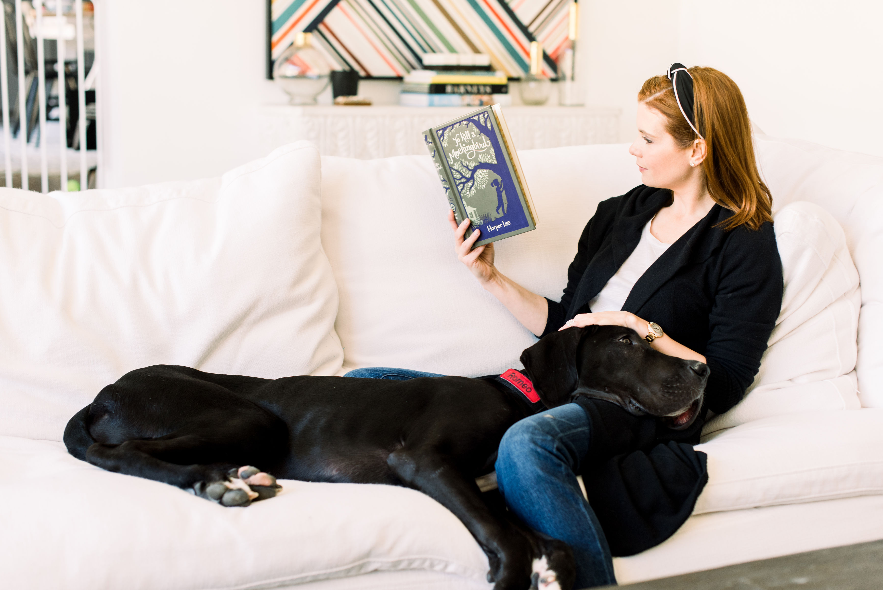 JoAnna Garcia Swisher reads a book with Romeo on her lap