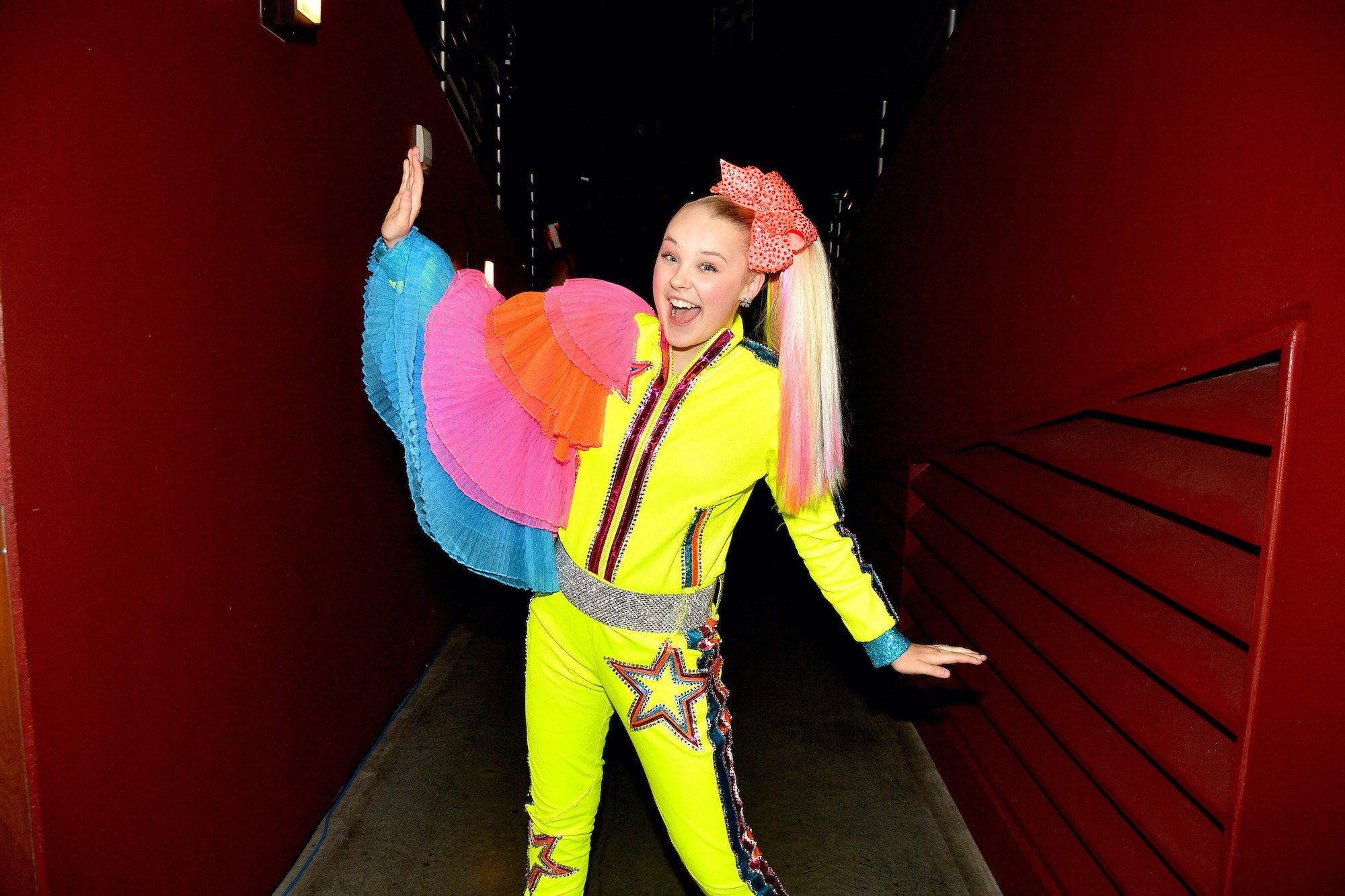 JoJo Siwa smiling in a hallway