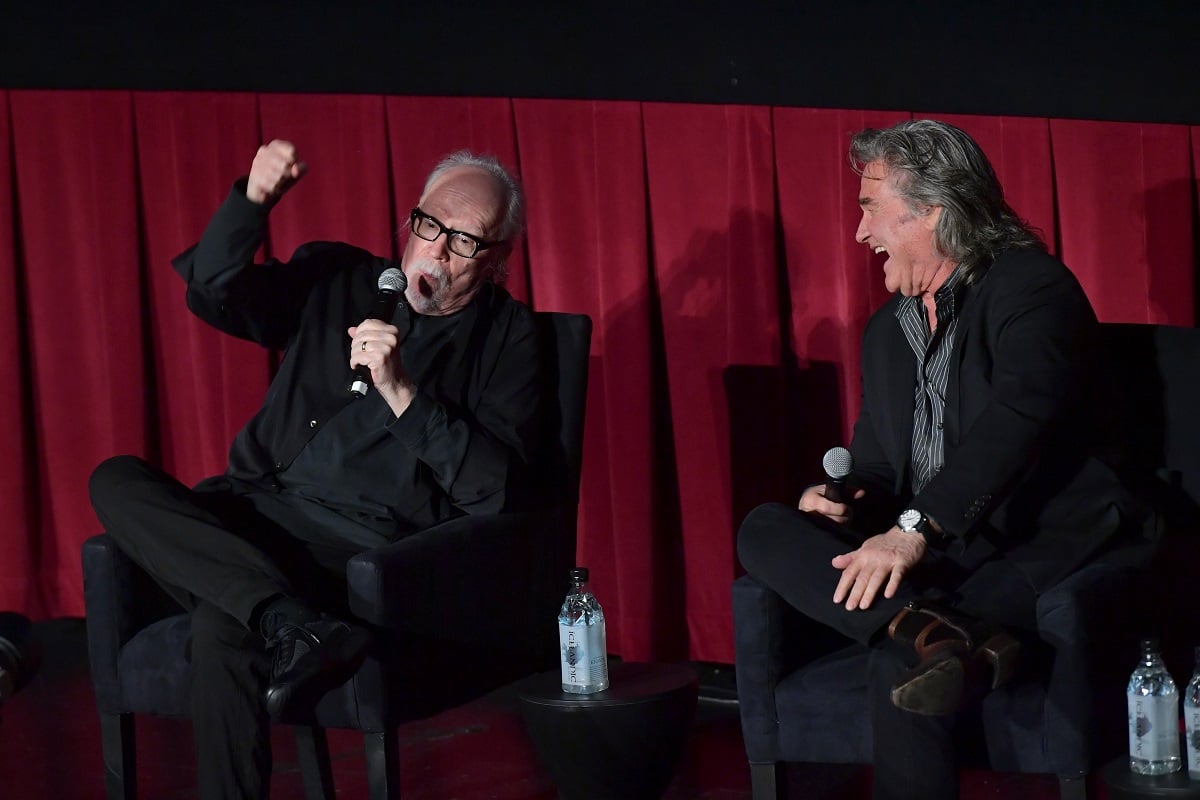 John Carpenter talks while Kurt Russell laughs at a screening.