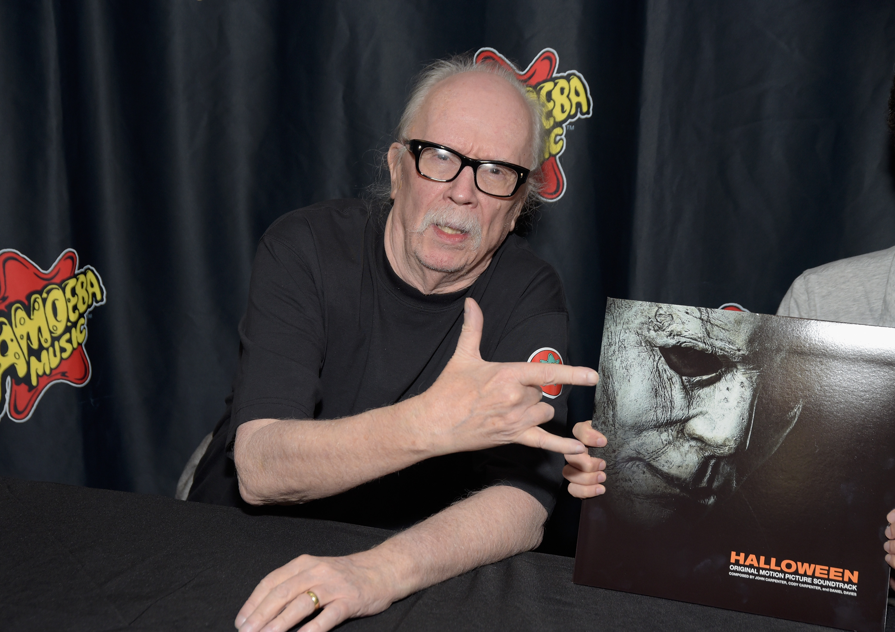 John Carpenter signing autographs at a Halloween horror movie event