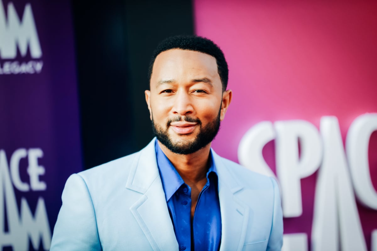 John Legend smiles for the camera at an event.