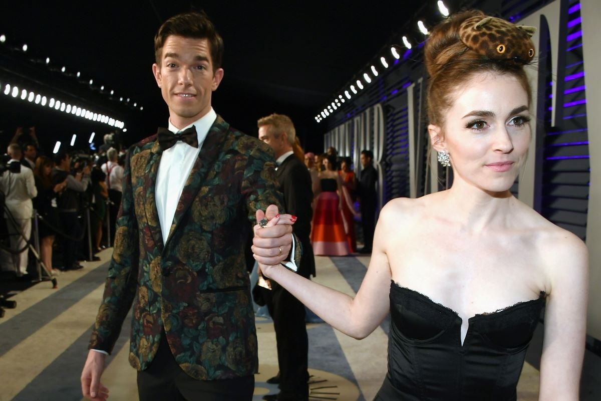 John Mulaney and Anna Marie Tendler holding hands.