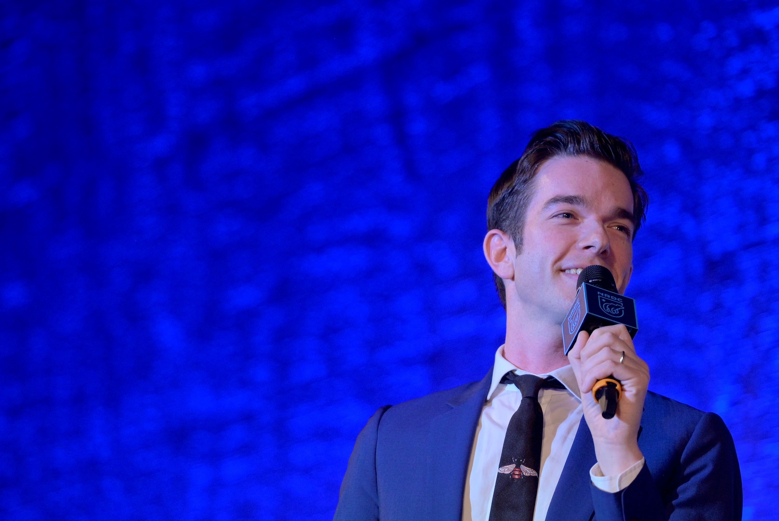 John Mulaney blue background