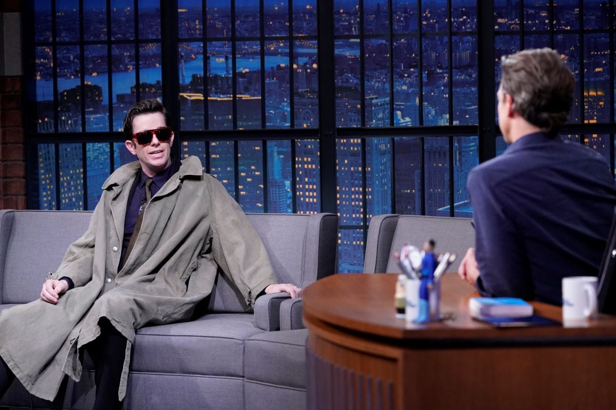 John Mulaney wears sunglasses in interview