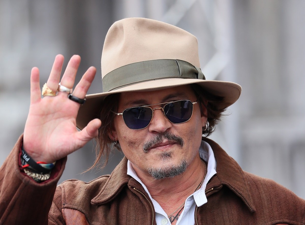 Johnny Depp waves at the camera.
